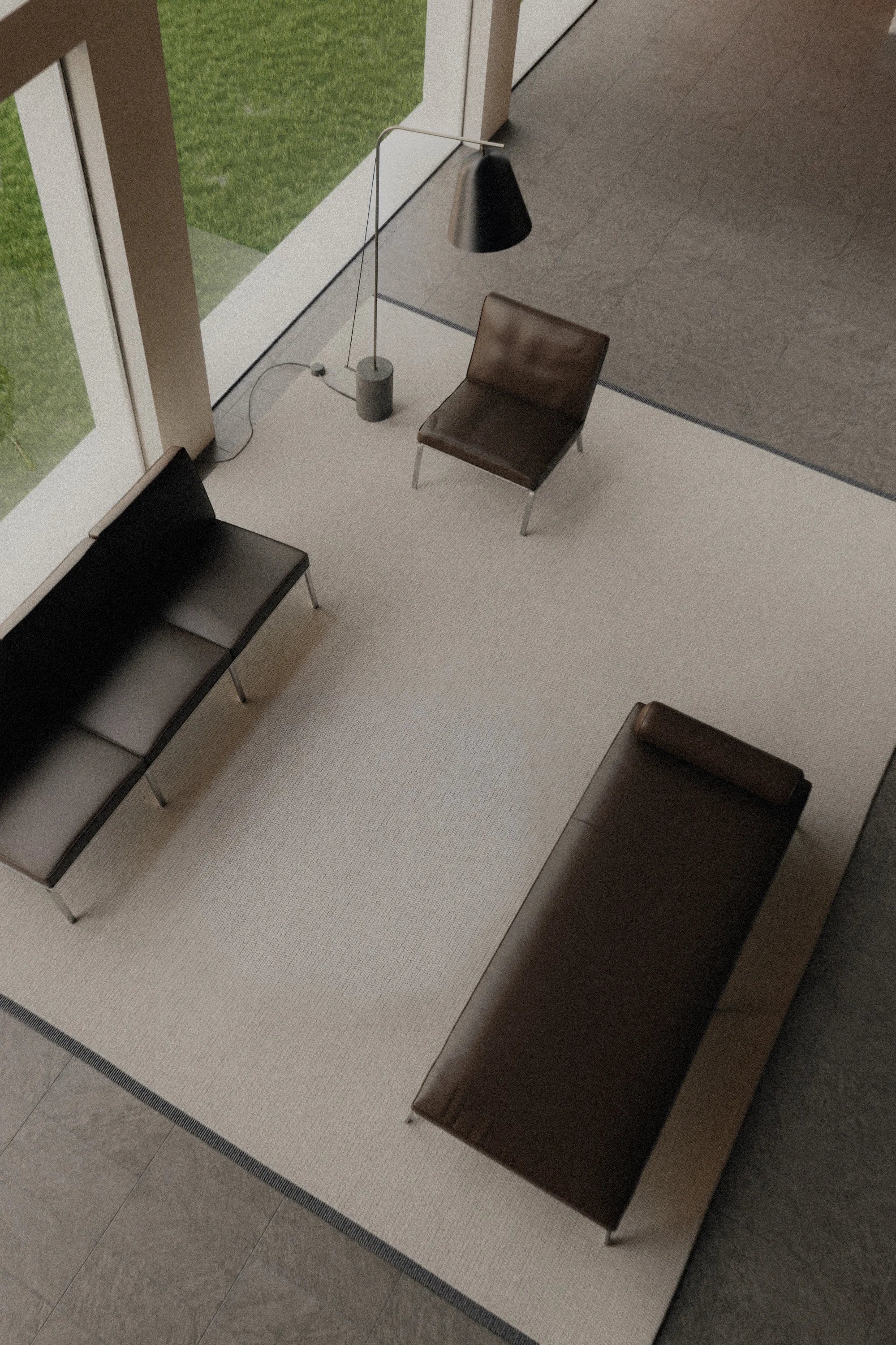 Modern interior with a sofa, armchair, and coffee table near large windows.