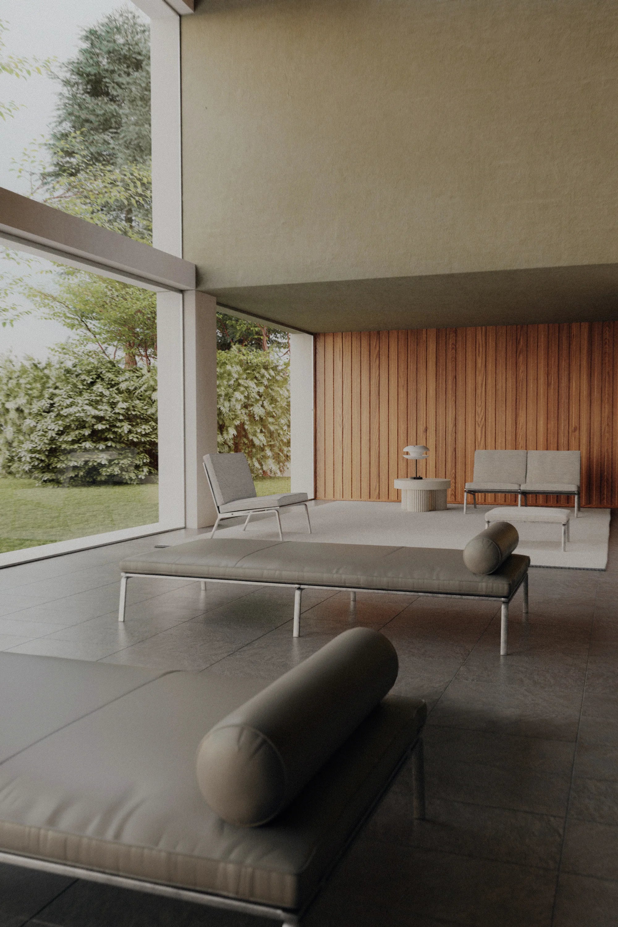 Modern outdoor living space with lounge chairs and a table near a glass wall.