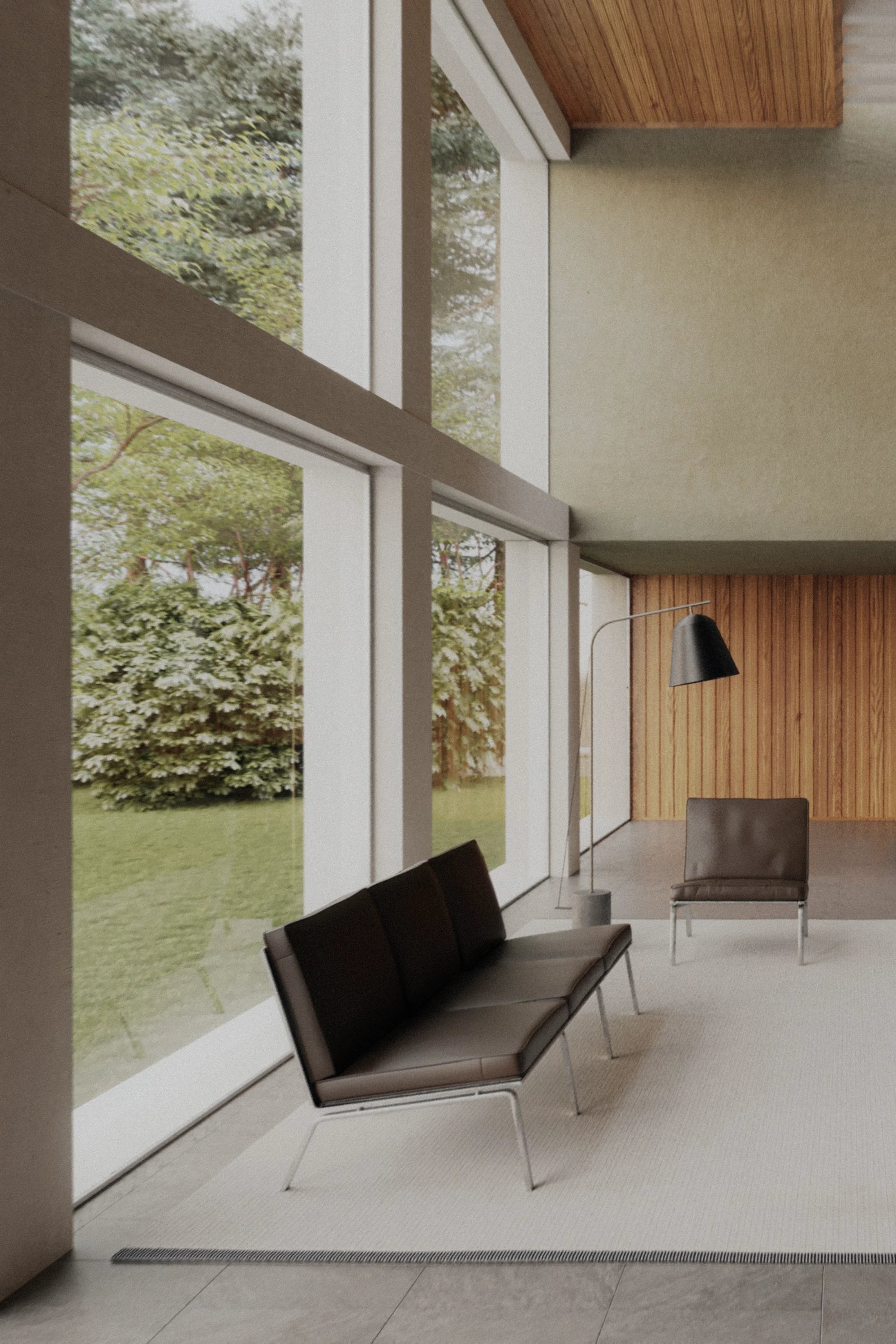 Modern interior with a large window view of greenery, featuring a black sofa and chair.