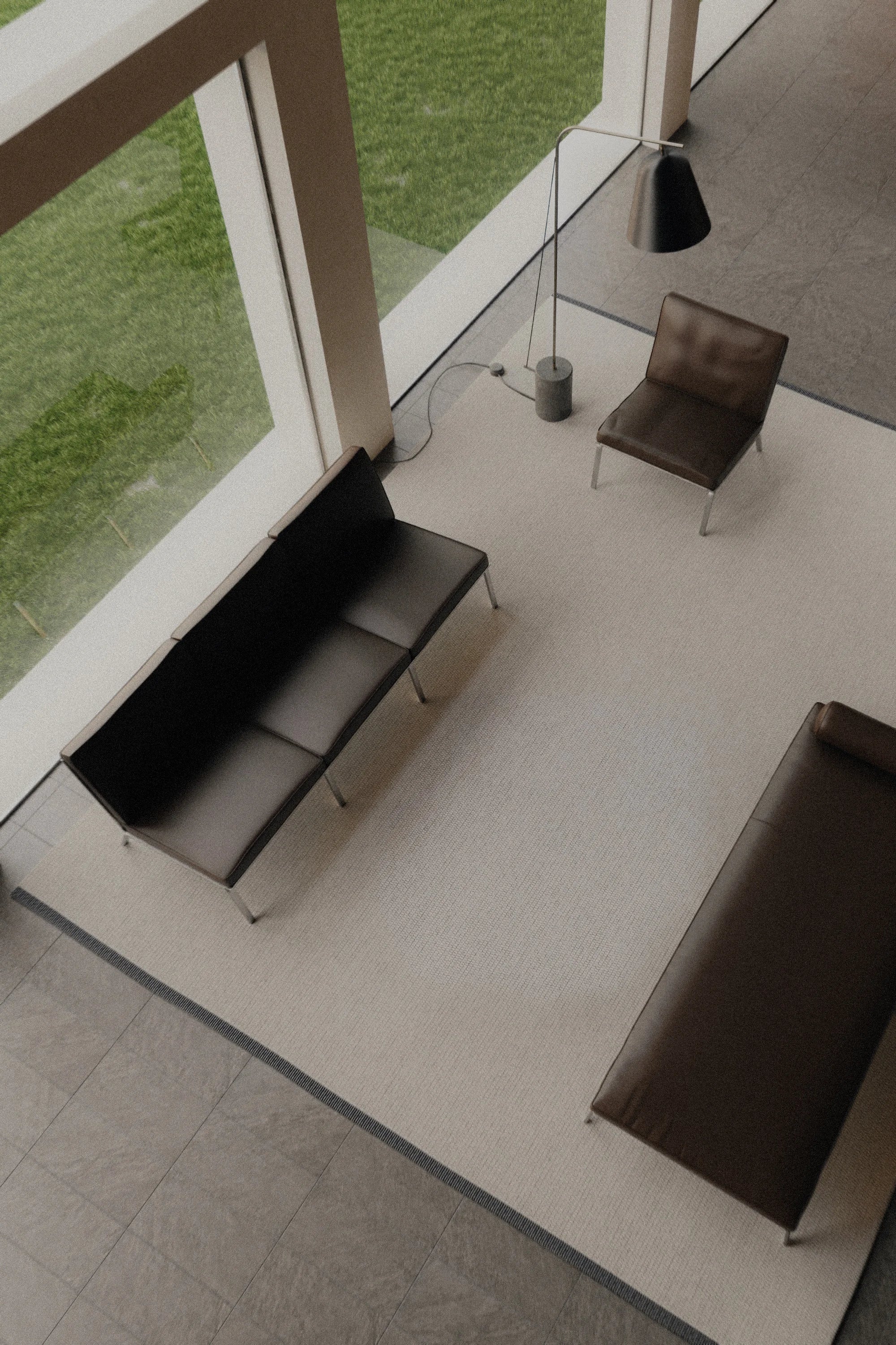 Modern interior with a black sofa and chair near large windows with a view of greenery.
