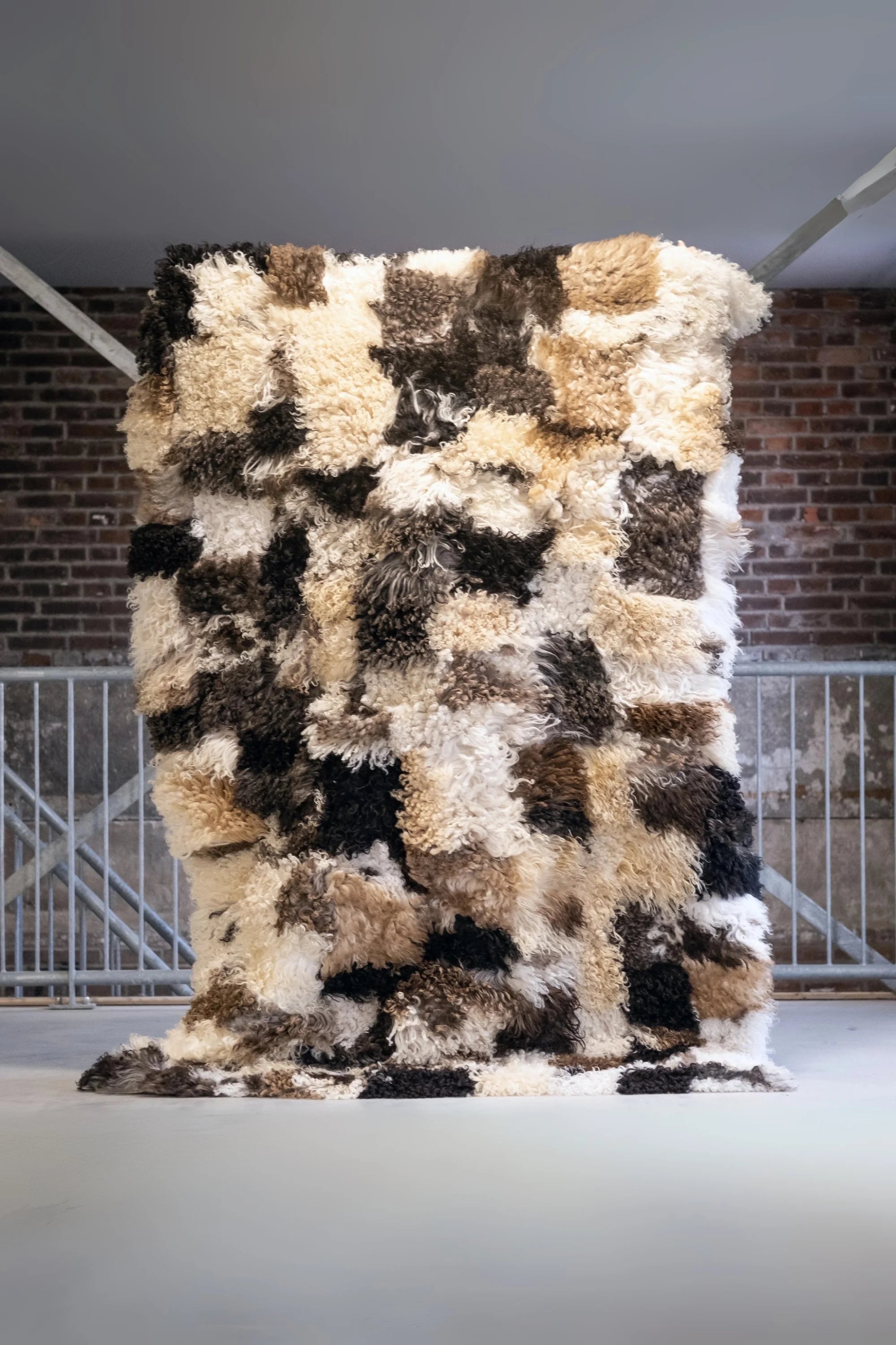 Multicolored textured rug on a plain surface with a neutral background