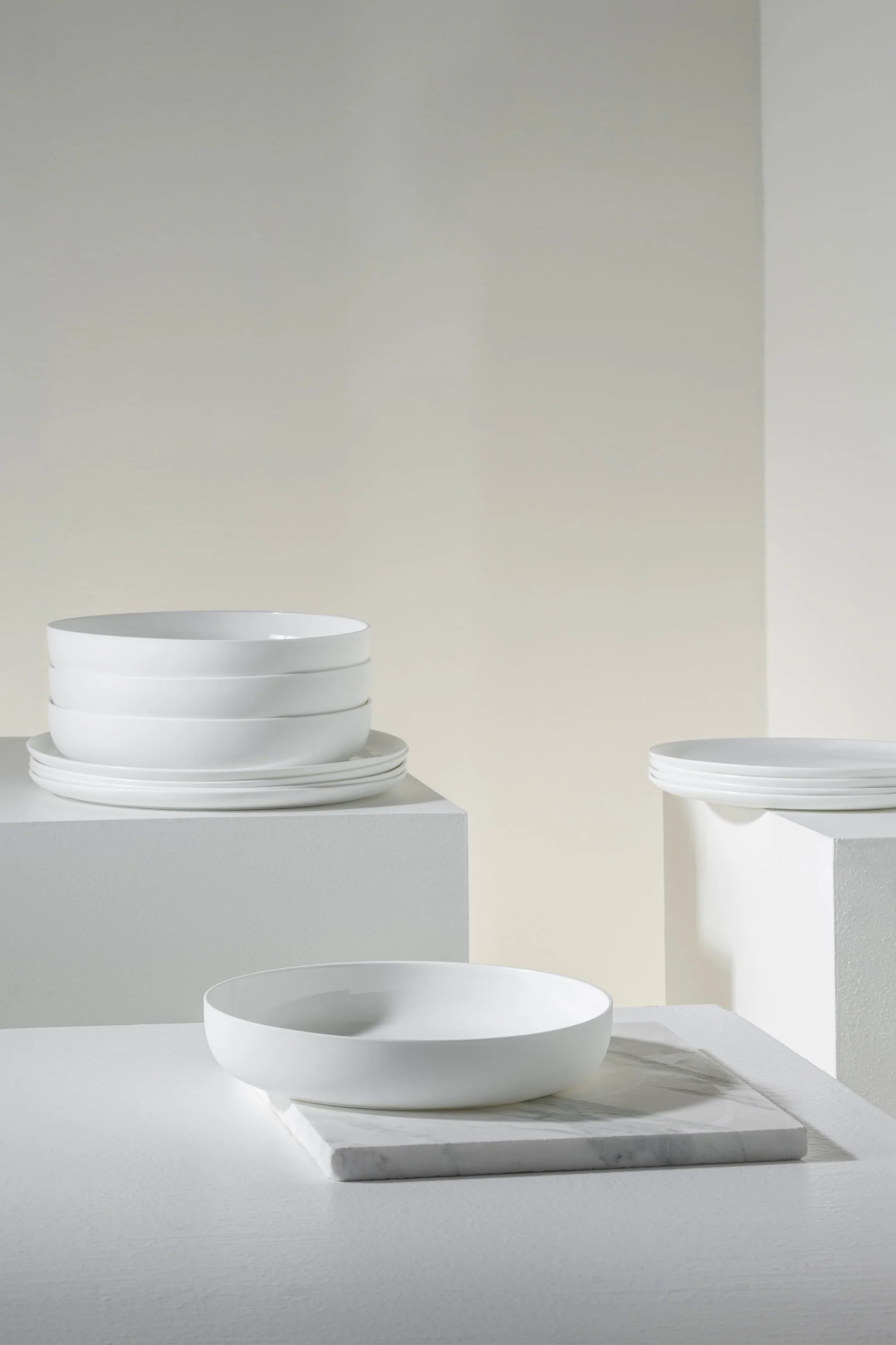 White ceramic bowls on a neutral background