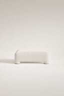 White ottoman on a light beige background