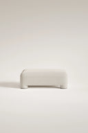 White ottoman on a light beige background