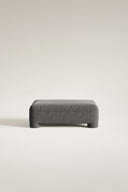 Gray upholstered bench on a light beige background