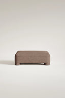 Brown ottoman on a light beige background