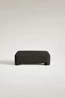 Dark gray ottoman on a light beige background