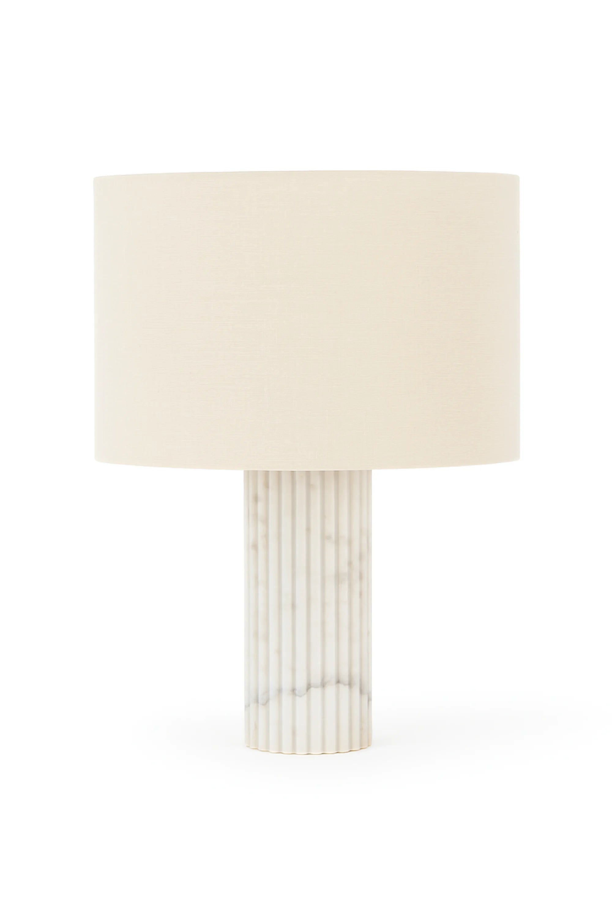 Table lamp with a cylindrical marble base and a beige lampshade on a white background
