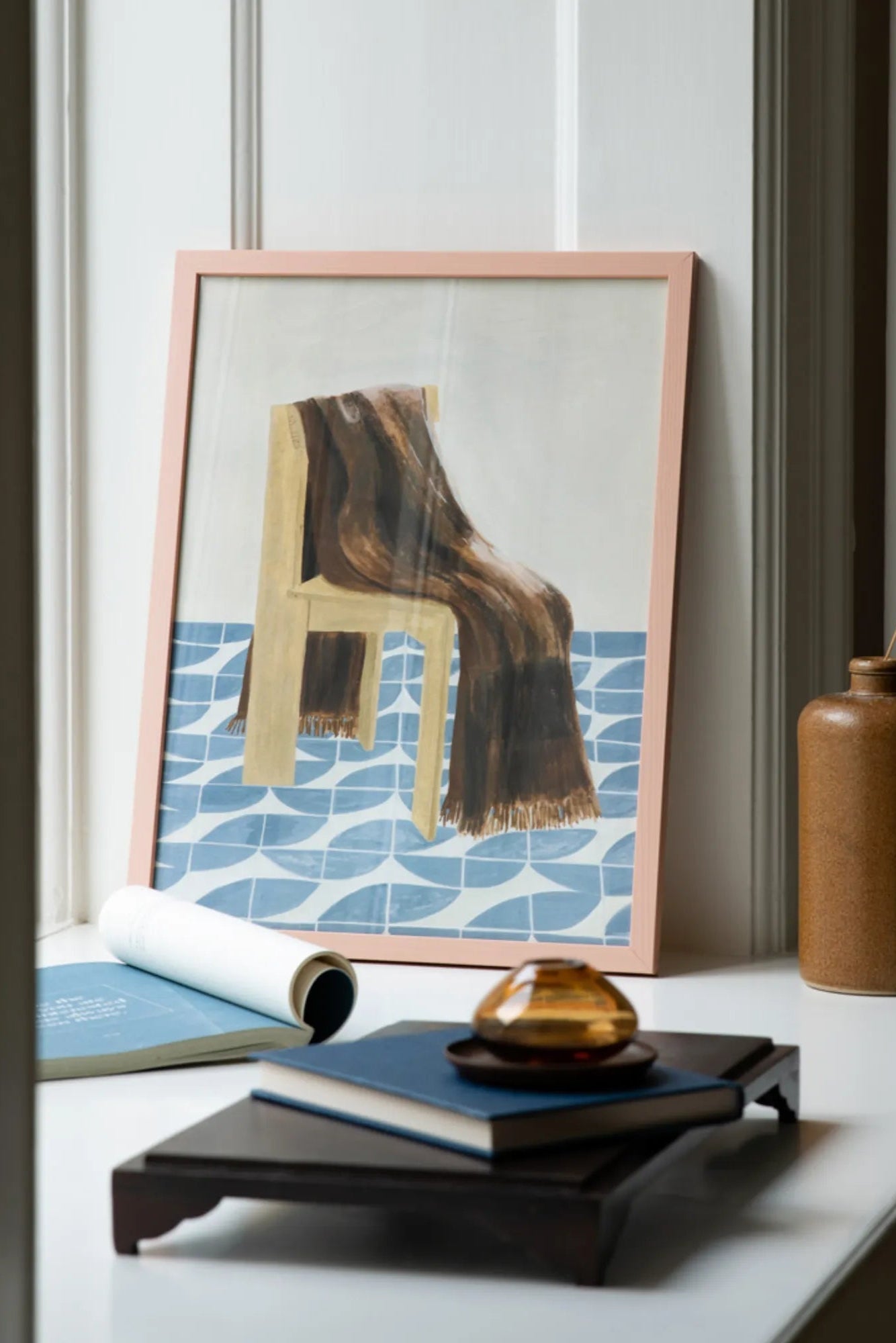 Cozy armchair with folded blanket and open book in home library