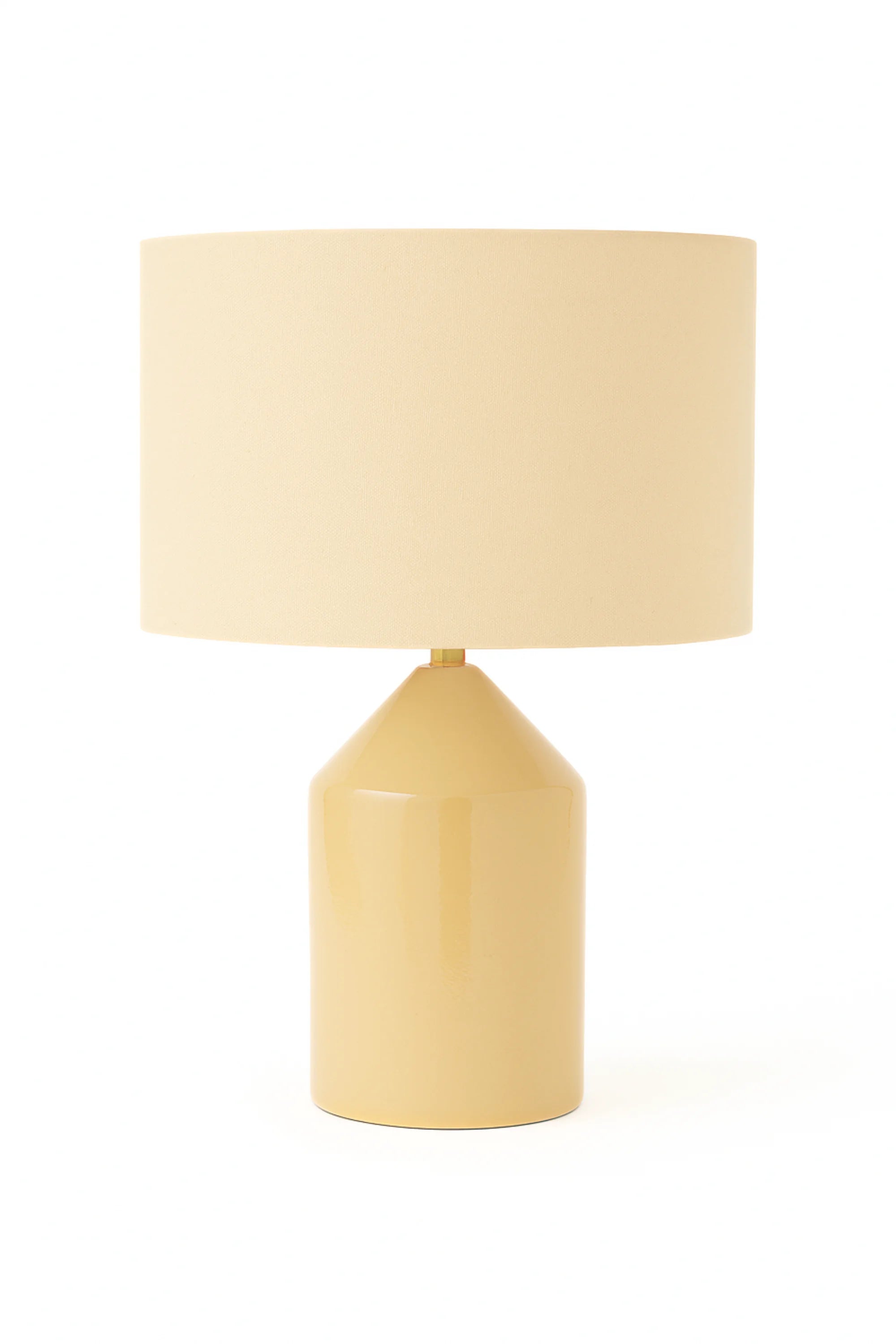 Yellow table lamp with a beige shade on a white background