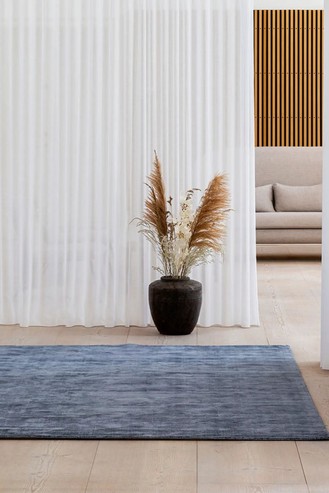 Spacious living room with a stylish and modern Karma Rug as the centerpiece