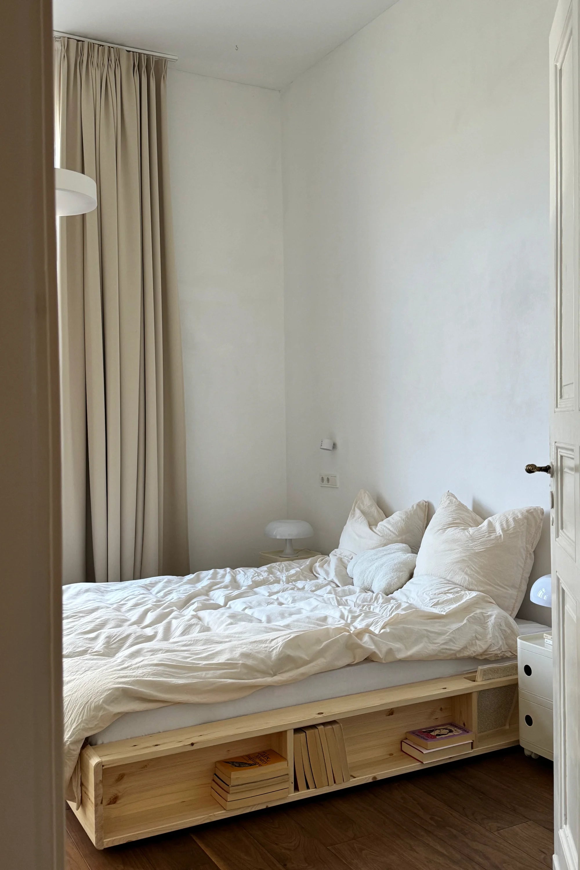 Bedroom with a wooden pallet bed and white bedding.