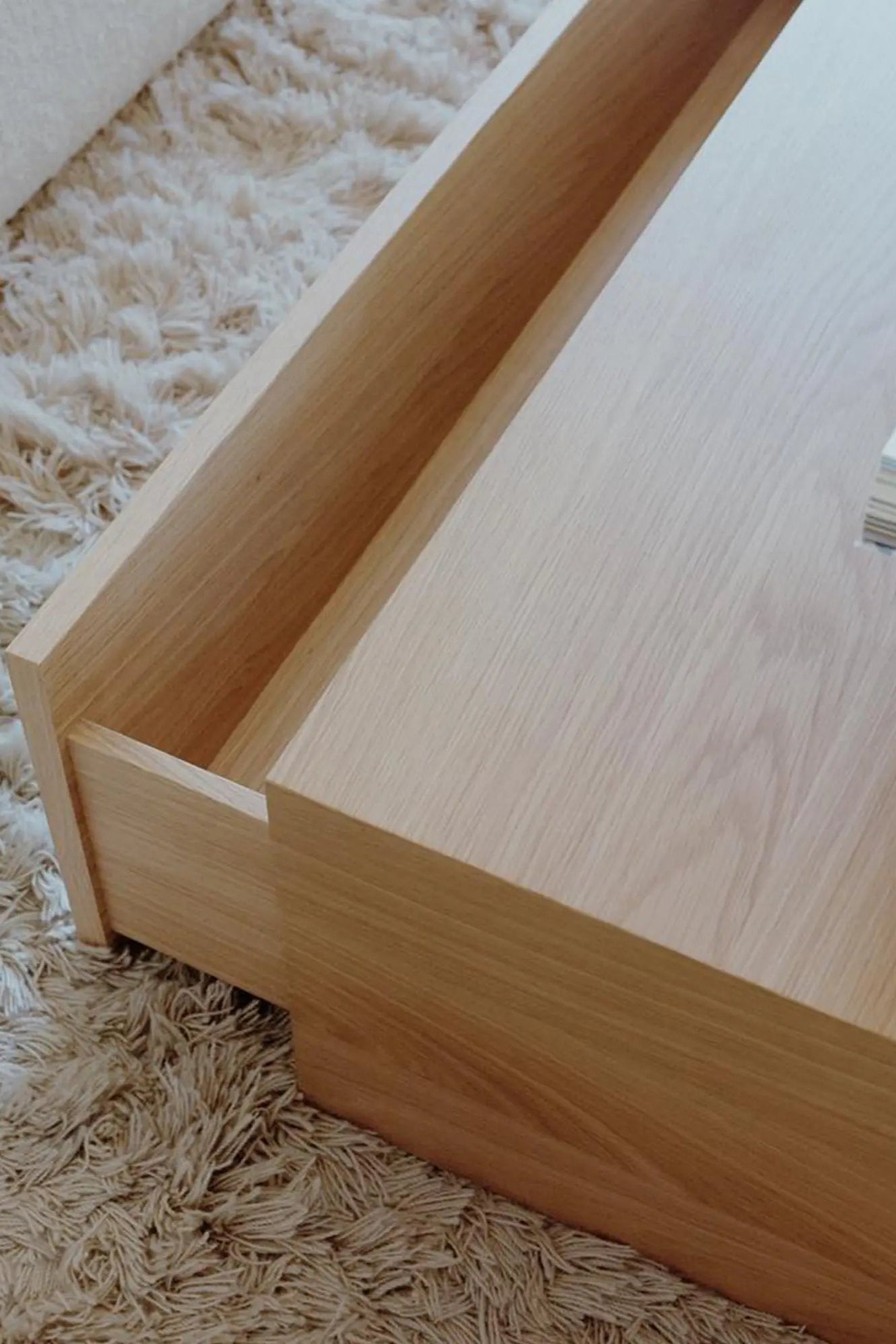 High coffee table with a deep drawer for storing books and remotes