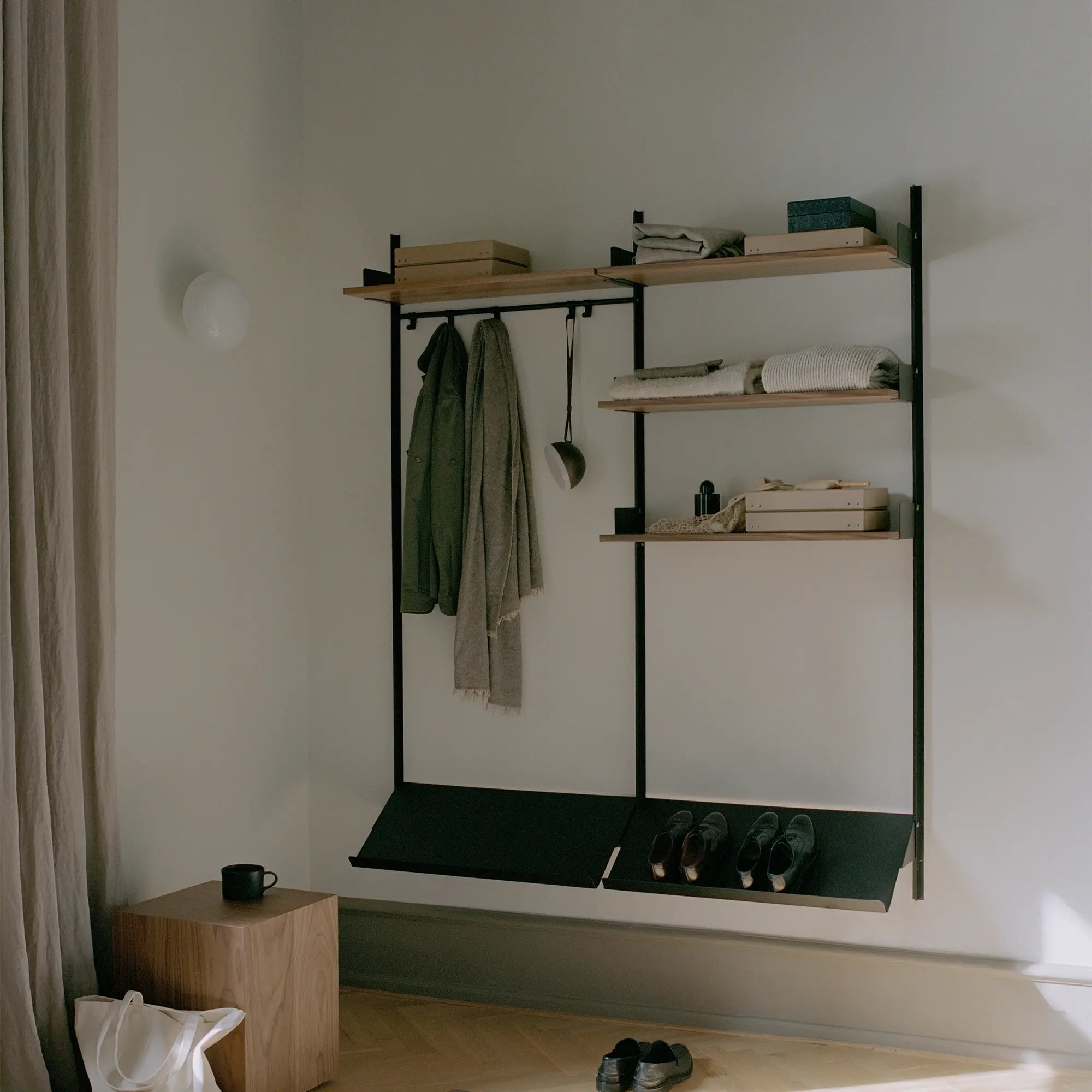 Close-up of sturdy metal frame and adjustable shelf brackets in wardrobe organizer