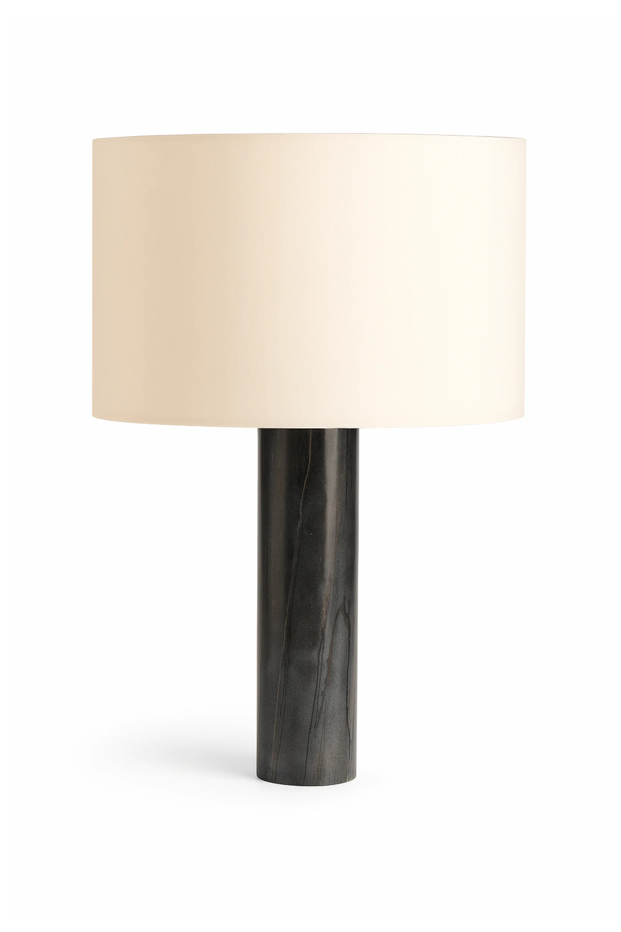 Table lamp with a beige shade and black base on a white background