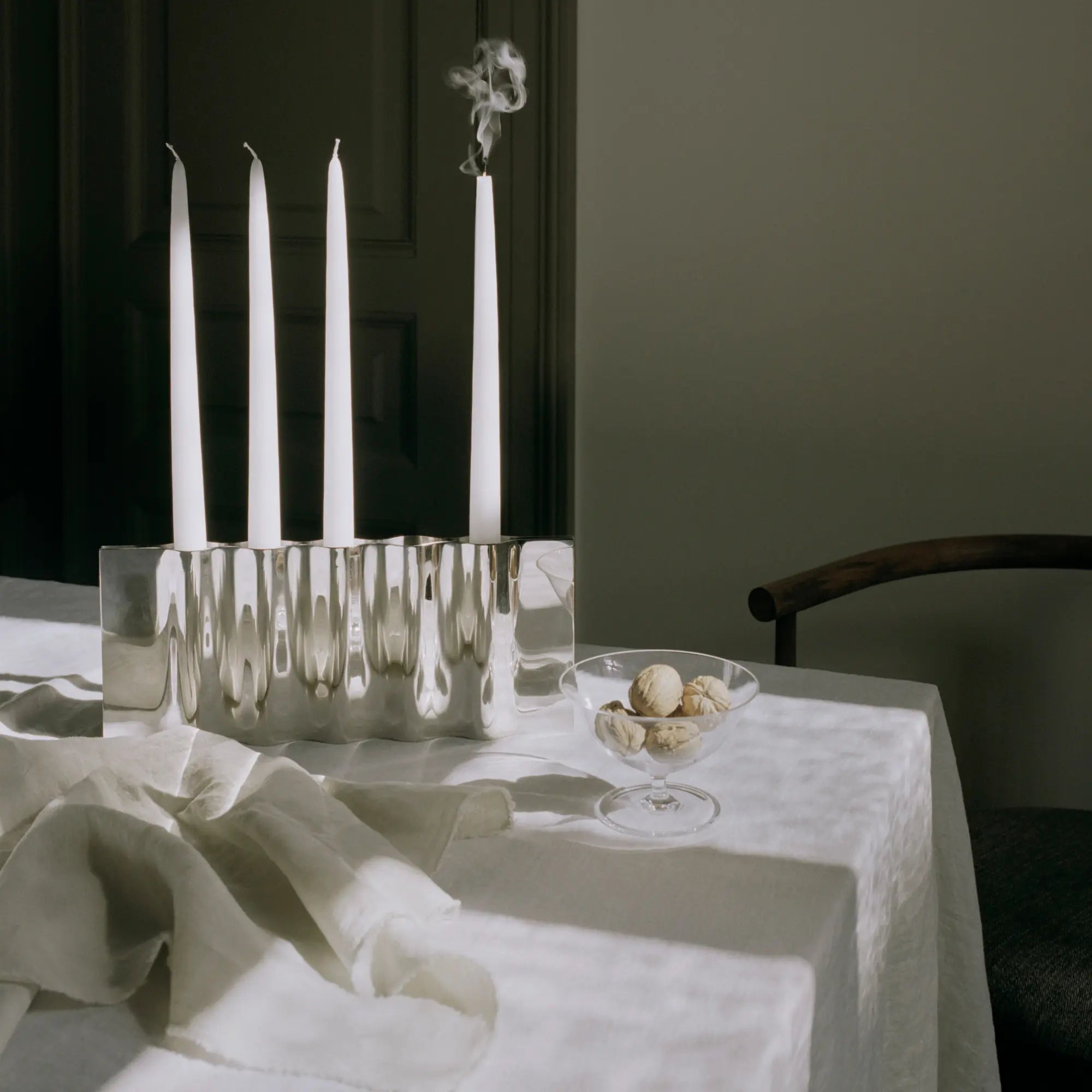 Close-up of Ripply Candle Holder with three candle slots and reflective surface