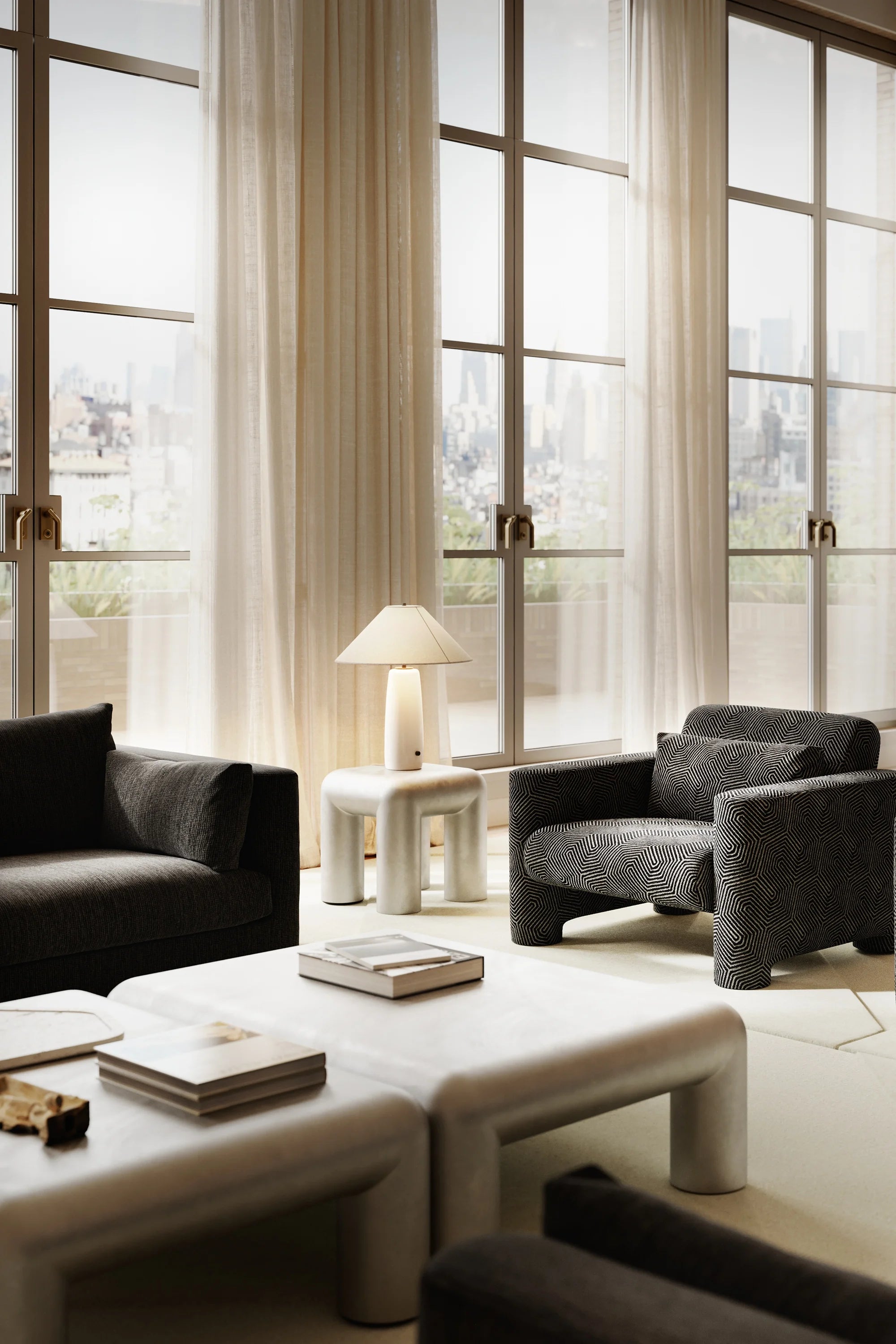 Modern living room with Formarkivet gray sofa, armchair, and coffee table in front of large windows.