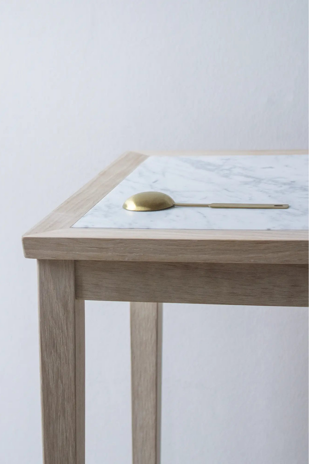 Minimalist No 1 Side Table with a round marble top and brass base