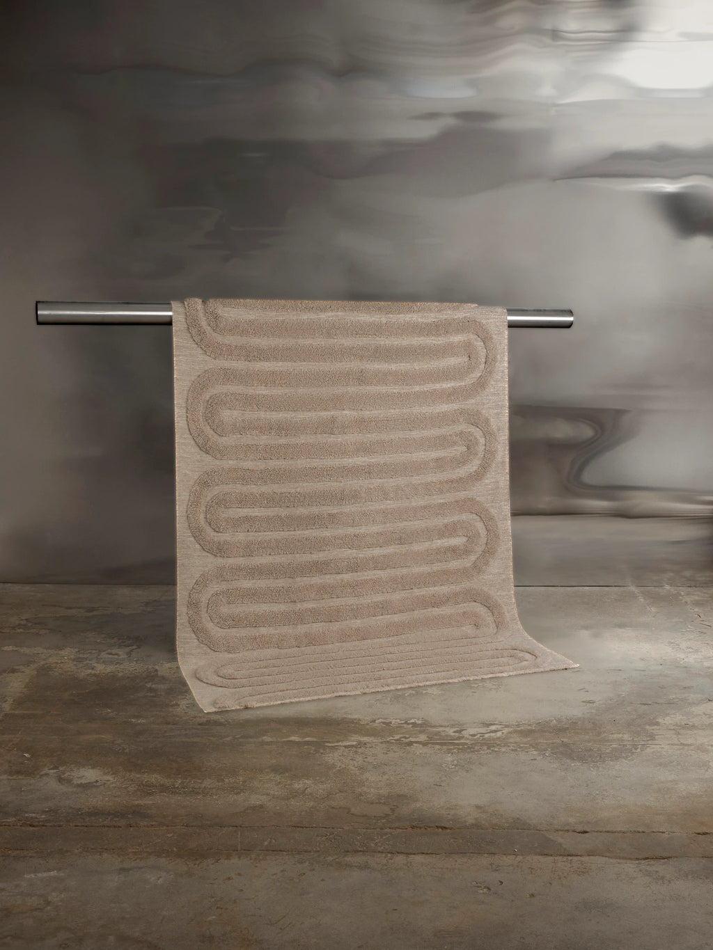 Tinted Objects Riklund Wool Rug, a plush beige modern area rug with an embossed wavy line pattern. This stylish and durable wool rug is perfect for adding warmth and contemporary design to any living space or bedroom.