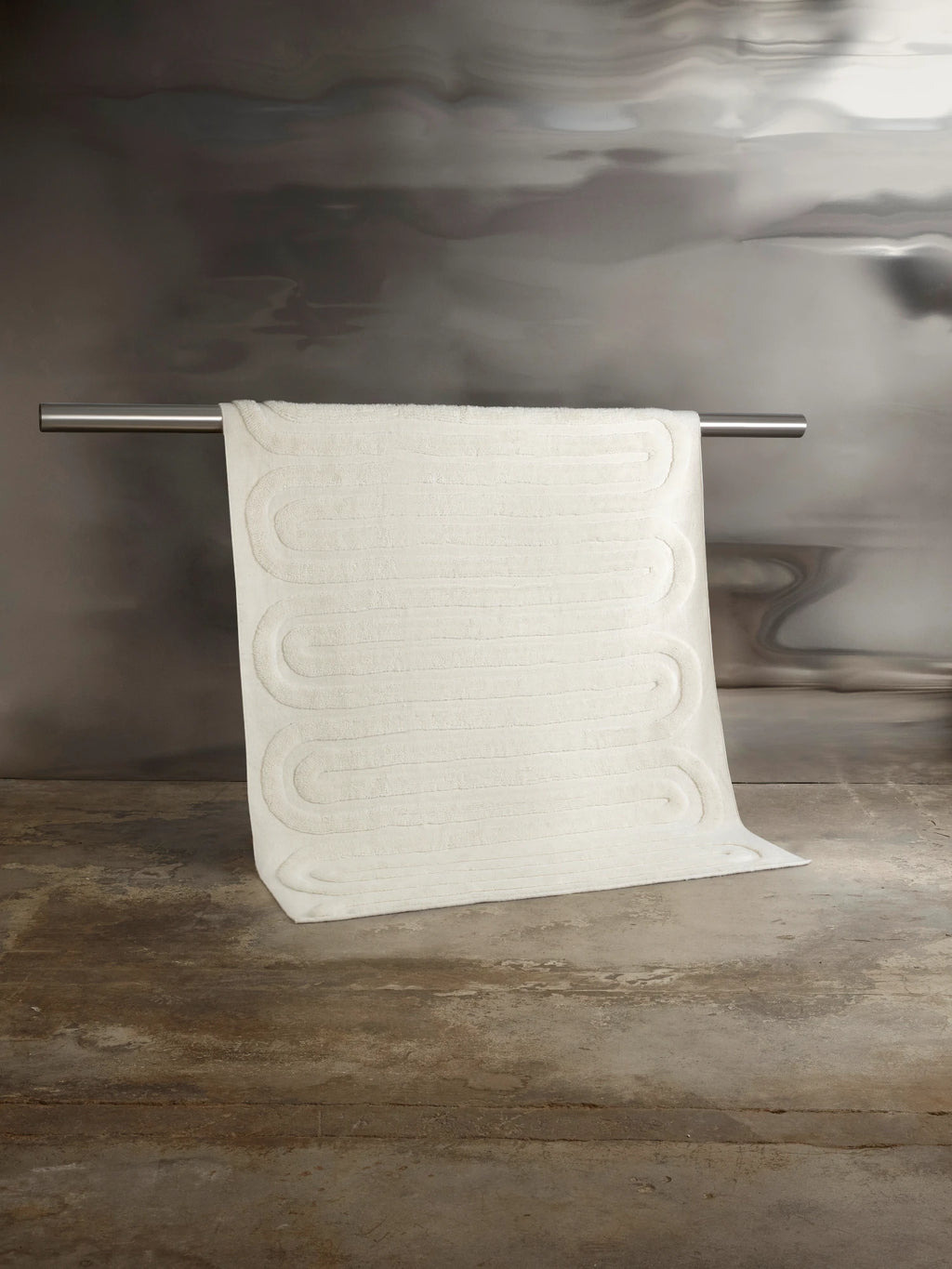 Tinted Objects Riklund Wool Rug, a plush off-white or cream-colored modern area rug with subtle raised loop patterns. This luxurious, soft wool rug adds warmth and contemporary style to any living space or bedroom.