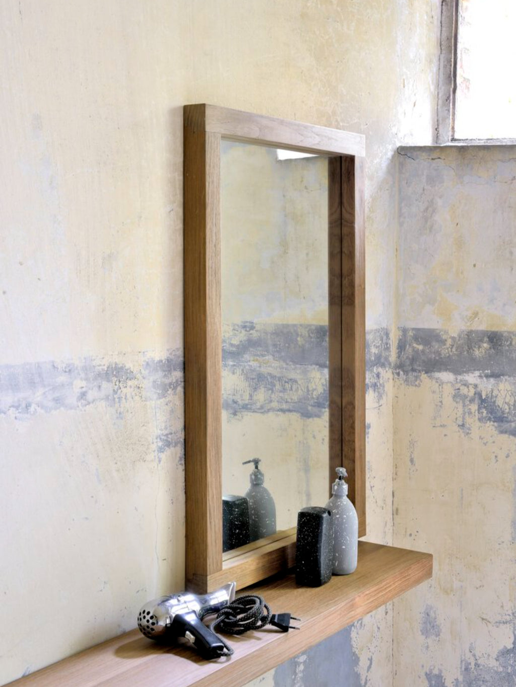 Ethnicraft Wall Shelf, a sleek solid oak floating shelf with clean, modern minimalist lines and a smooth, warm natural wood grain finish. This contemporary Scandinavian-inspired wall shelf provides elegant storage for bathrooms, entryways, or living room decor.