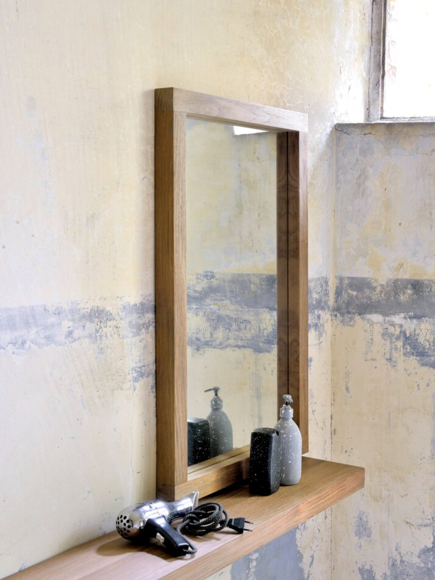 Ethnicraft Wall Shelf, a sleek solid oak floating shelf with clean, modern minimalist lines and a smooth, warm natural wood grain finish. This contemporary Scandinavian-inspired wall shelf provides elegant storage for bathrooms, entryways, or living room decor.