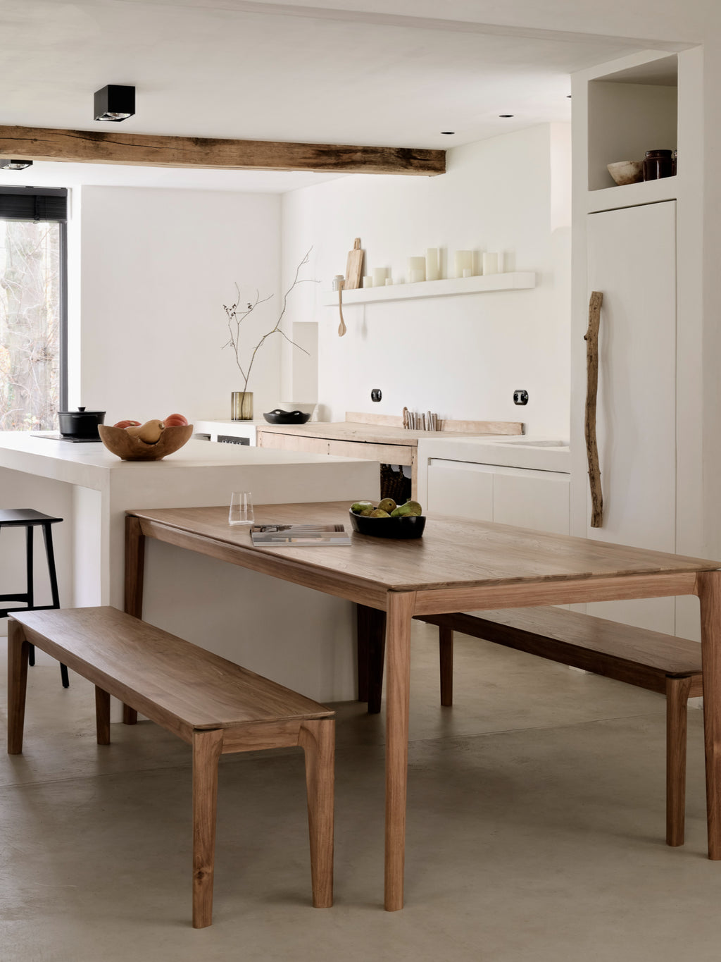 Ethnicraft Bok Bench, a modern minimalist solid oak bench crafted from natural light brown wood, featuring a sleek rectangular seat and elegantly tapered legs. Its clean lines and smooth wood grain embody a contemporary Scandinavian design aesthetic, making it an ideal dining bench for modern kitchens or a stylish entryway bench for organic modern interiors.