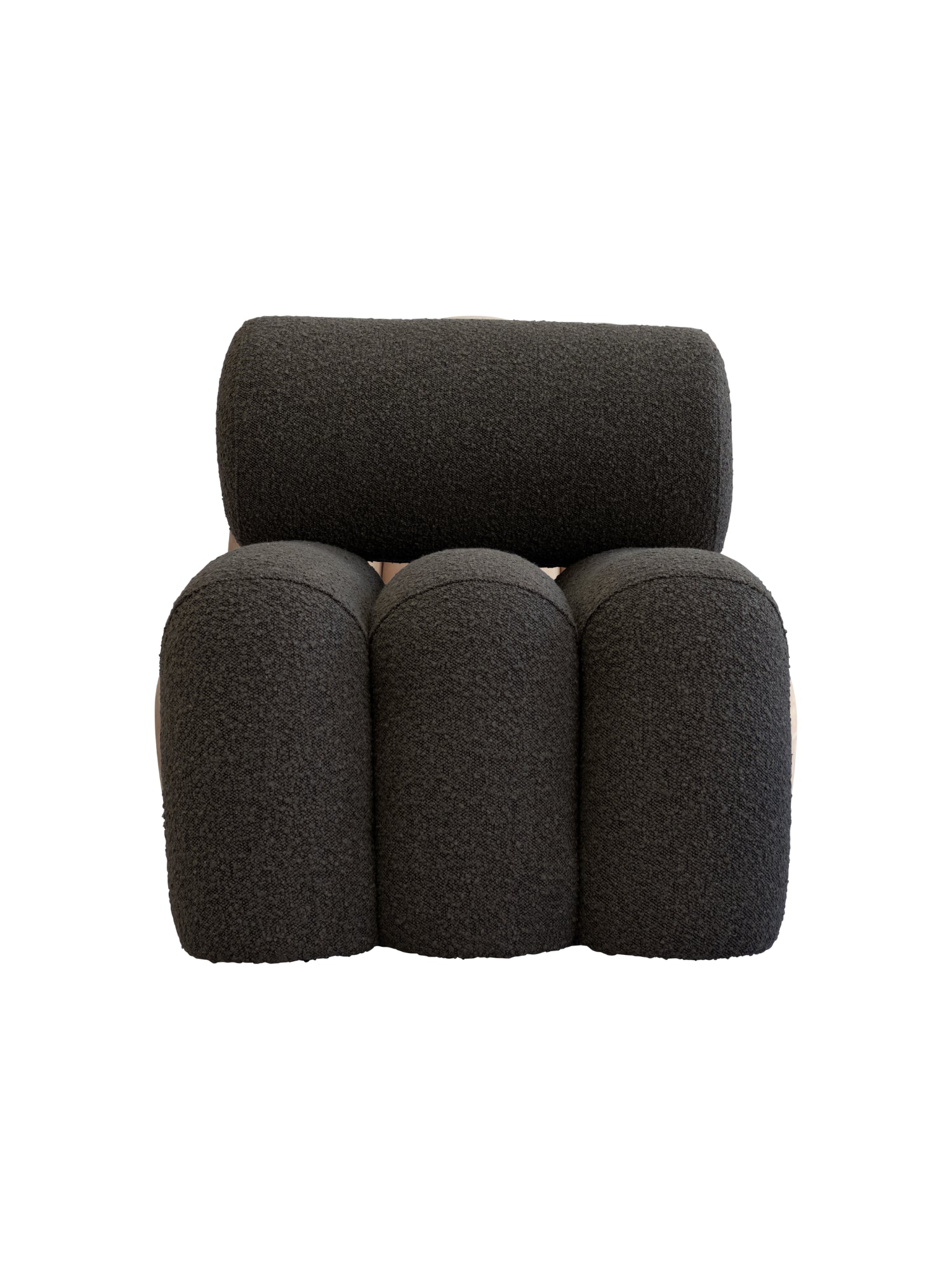 101 CPH Foku Lounge Chair in a studio shot. This premium, modern design features three plush, rounded charcoal grey boucle upholstered sections forming the back and seat, with a single cylindrical charcoal grey boucle pillow serving as the backrest. Its unique organic shape offers luxurious comfort. Ideal for contemporary living spaces.