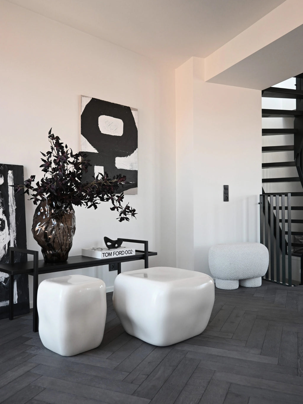 101 CPH Ishi Coffee Table Set - Ceramic: Two organic, free-form glossy white ceramic tables on dark herringbone flooring. These modern, luxury accent tables suit contemporary living spaces.