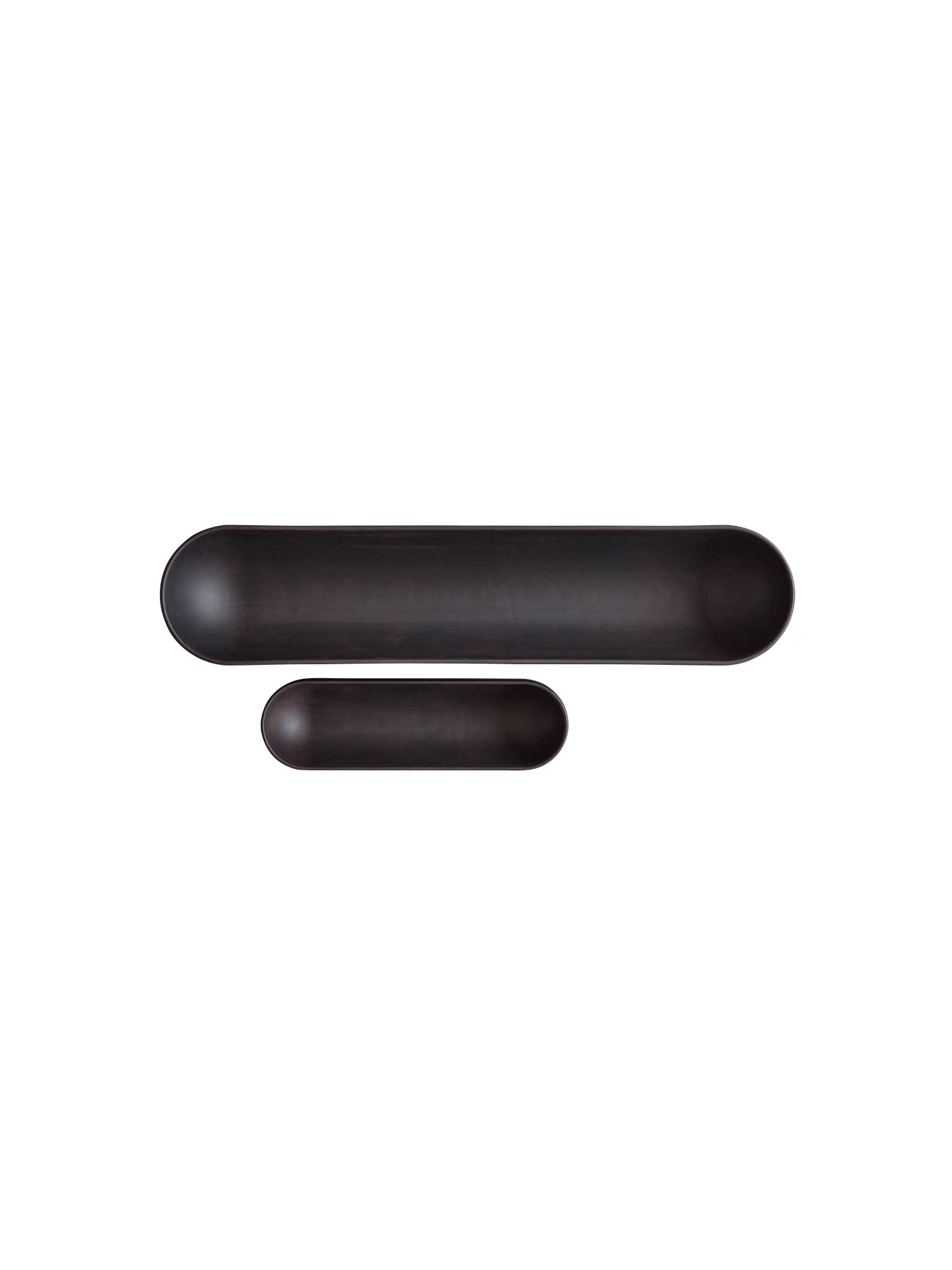 101 CPH Shinju Tray. Two elongated, capsule-shaped matte dark brown or black ceramic trays, one larger and one smaller, artfully arranged on a white background. Perfect for modern home decor.