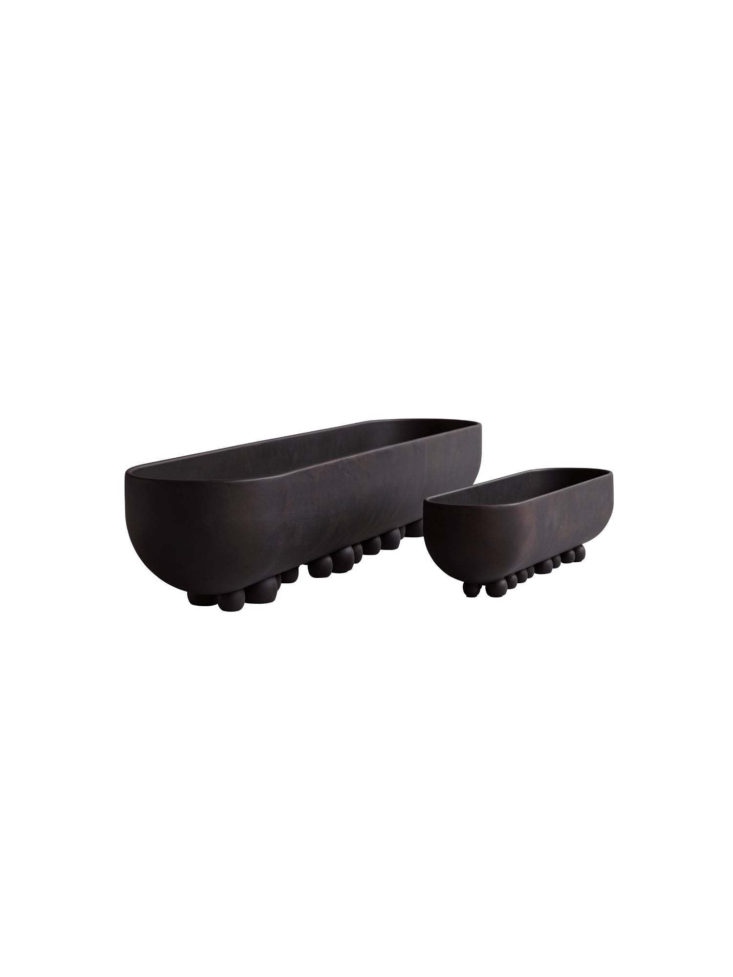 101 CPH Shinju Tray. Two dark brown, elongated oval ceramic trays, one large and one small, featuring distinctive round ball feet. Perfect for elegant decorative display.