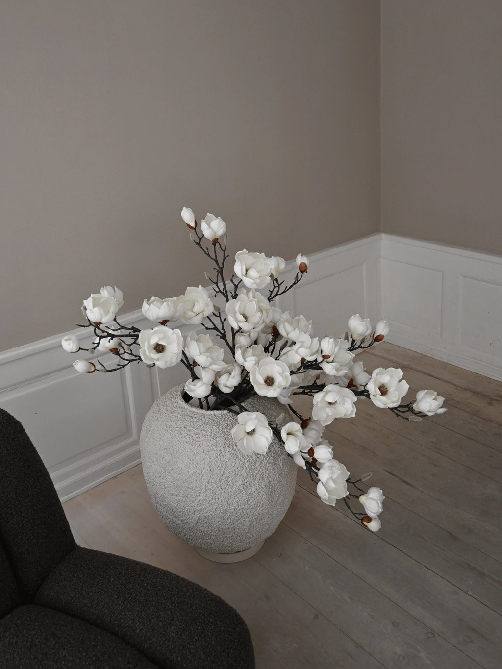 101 CPH Sunao Planter in light grey ceramic with a unique, textured, organic finish, displayed with white magnolia branches on a light wood floor. A premium home décor accent.
