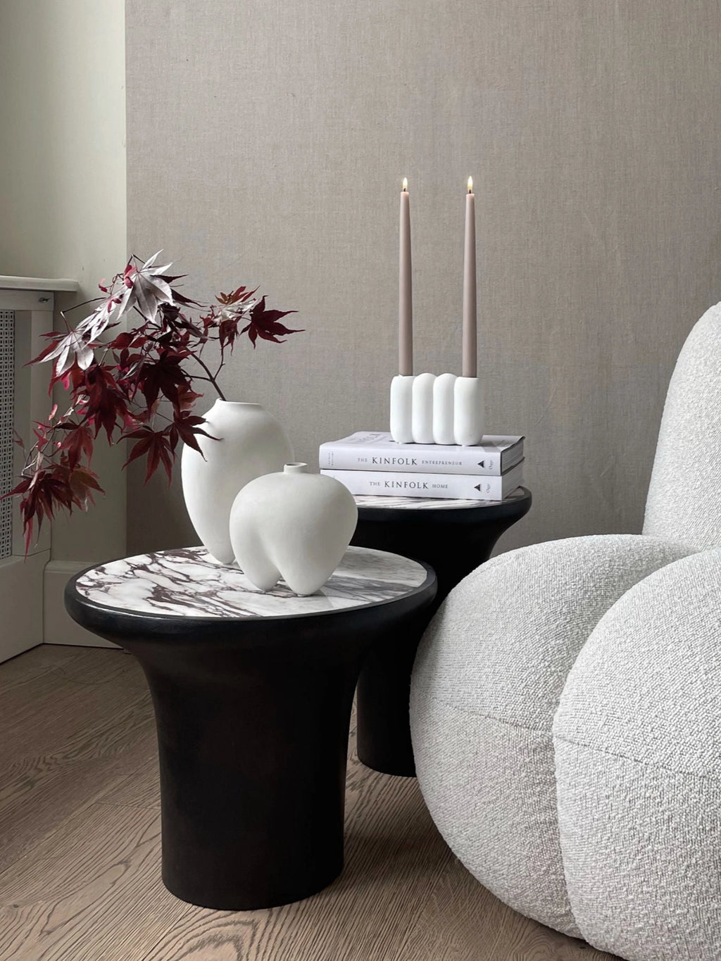 101 CPH Trumpet Side Table in a lifestyle setting, showcasing its black conical base and luxurious white marble top with dark veining. This premium accent piece is ideal for modern living spaces.