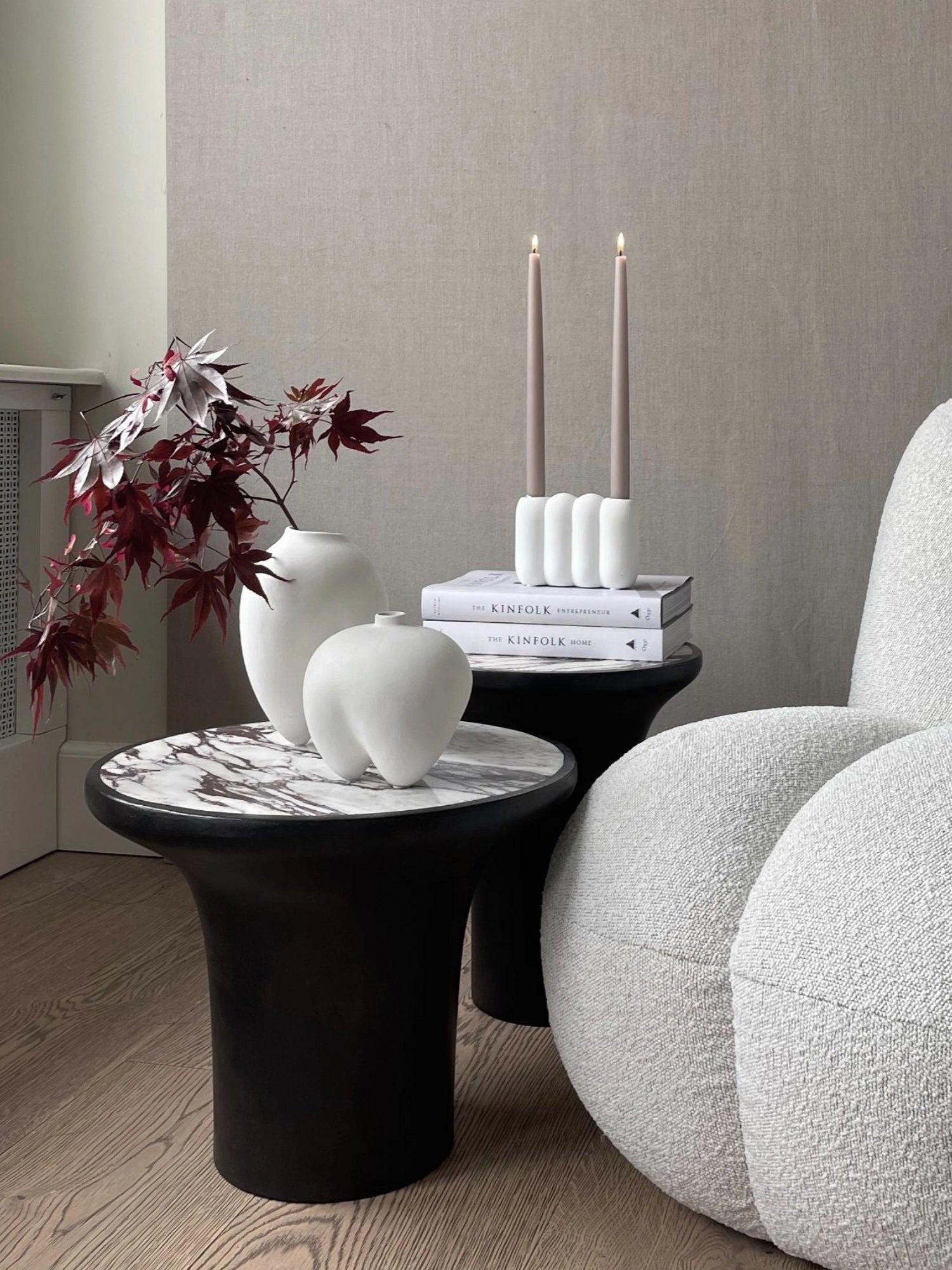 101 CPH Trumpet Side Table in a lifestyle setting, showcasing its black conical base and luxurious white marble top with dark veining. This premium accent piece is ideal for modern living spaces.
