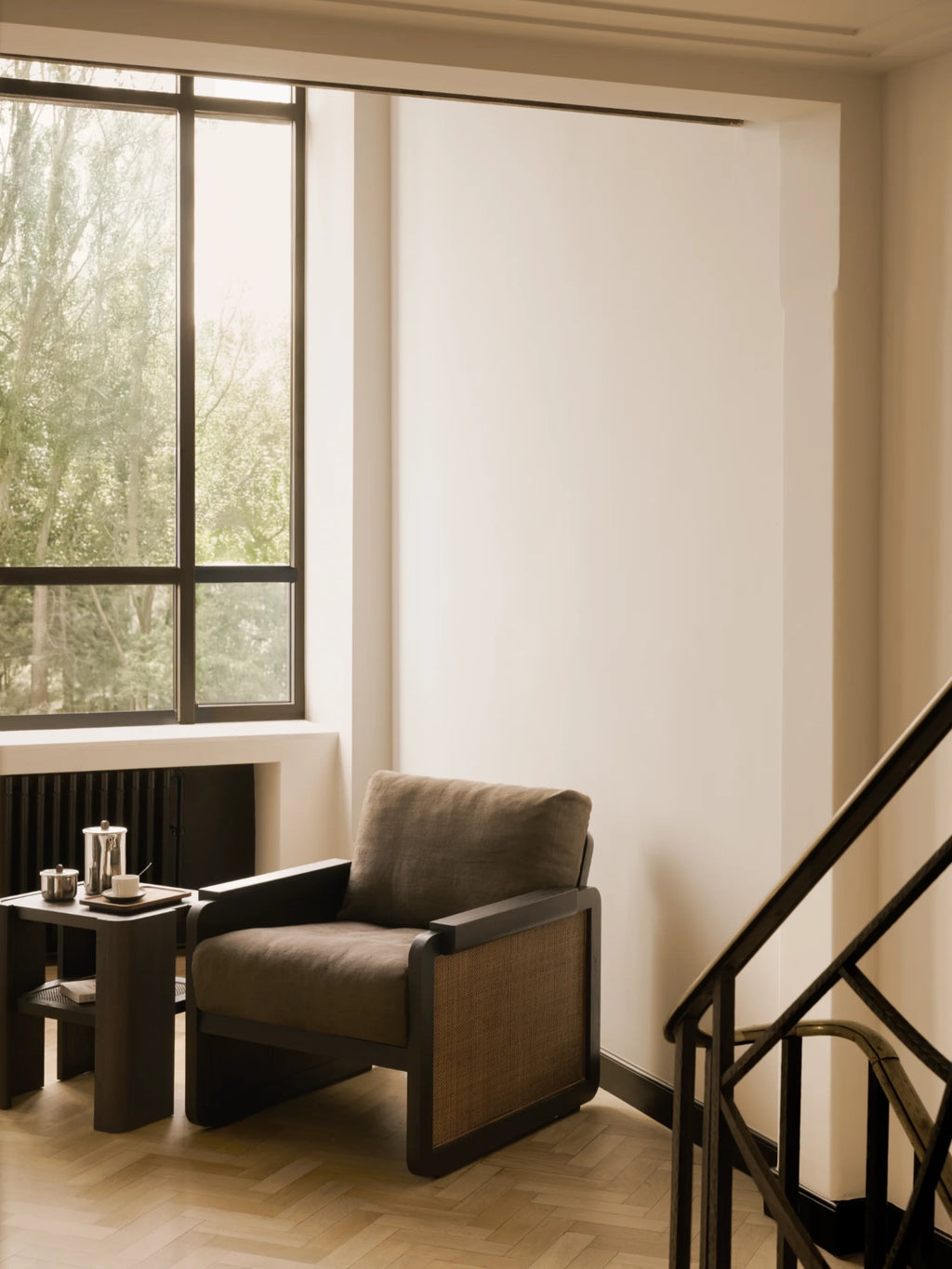 Ethnicraft Panel Lounge Chair, a modern minimalist armchair featuring a dark-stained solid wood frame with clean lines and natural hand-woven cane panels on the sides, complemented by deep, plush cushions upholstered in.