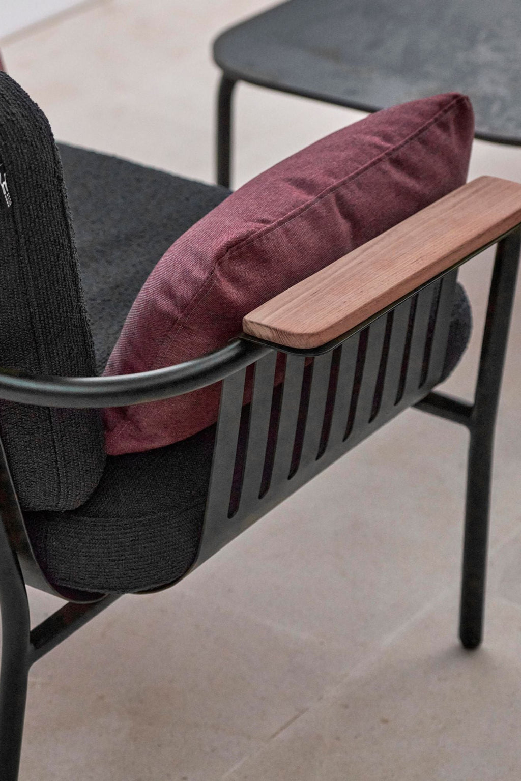 Gandia Blasco Capa 2-Seat Sofa, a modern outdoor sofa featuring a sleek matte black powder-coated aluminum frame with distinctive slatted side panels and warm natural solid wood armrests.