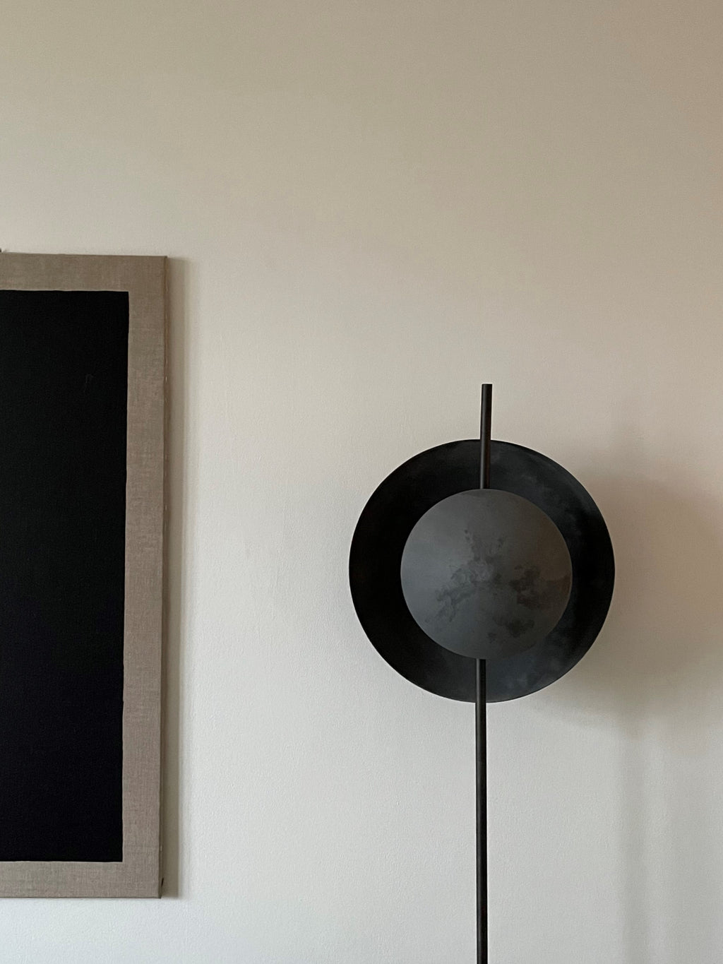 101 CPH Dawn Floor Lamp, featuring a unique matte black and dark grey spherical and circular metal design on a slender rod, showcasing modern luxury lighting. Ideal for contemporary interiors.