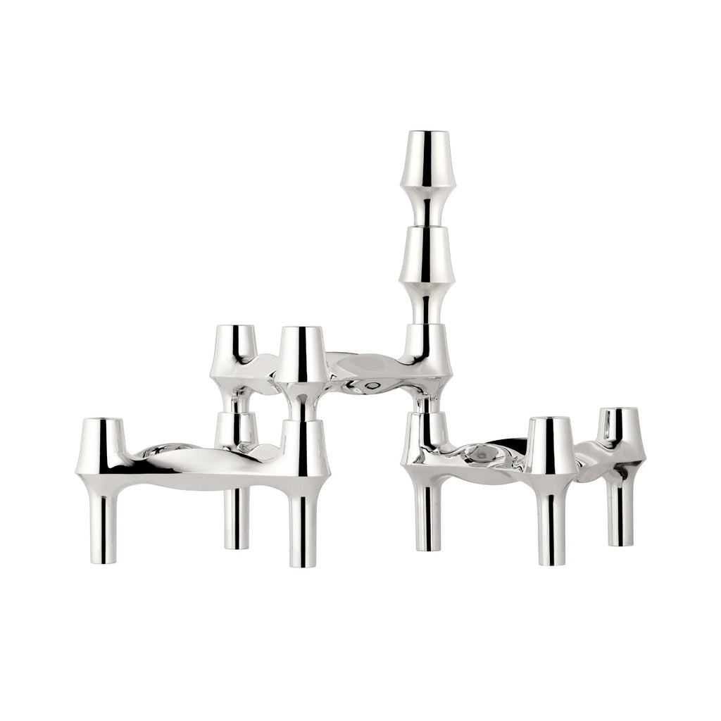 Stoff Nagel BMF Candle Holder - Configuration 1, a striking mid-century modern modular candle holder crafted from highly polished chrome-plated metal with a reflective silver finish. Its unique sculptural design features interlocking elements forming an architectural silhouette, configured to hold three taper candles.