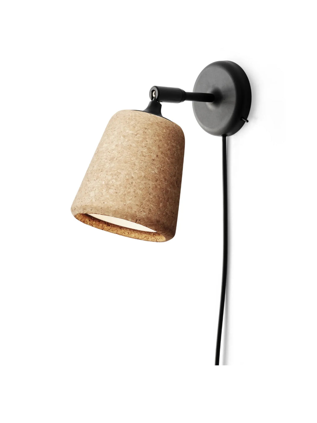 New Works Material Wall Lamp: A minimalist wall-mounted light featuring a natural cork cone shade, black matte metal base, and exposed black cord, casting a warm designer glow.