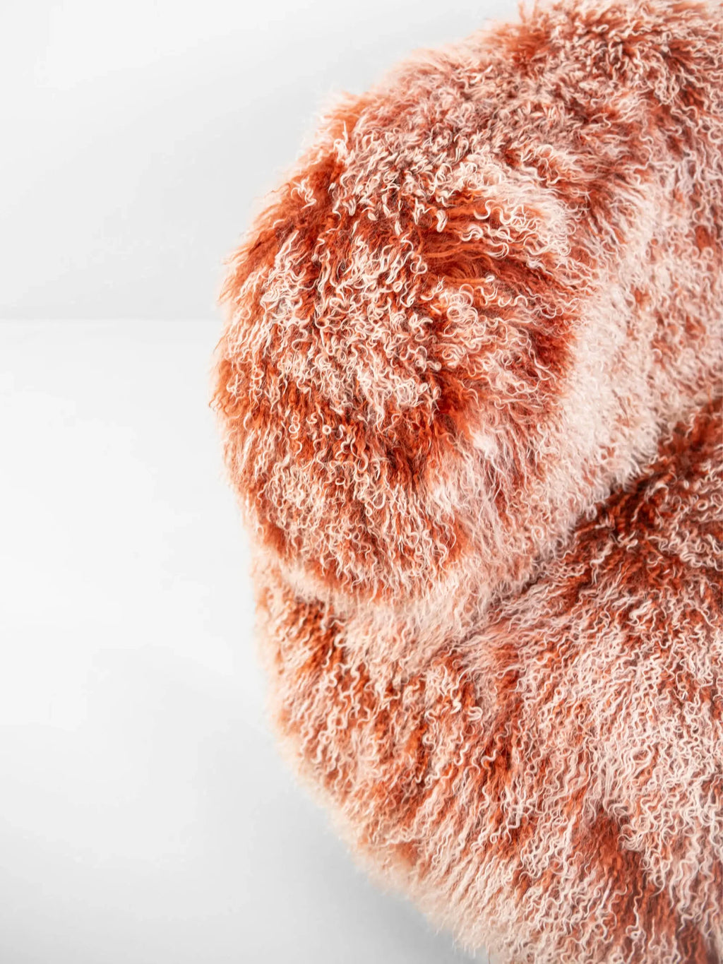 Hessentia Lullaby Armchair, a luxurious organic modern lounge chair upholstered in a rich, multi-tone curly shaggy fabric, featuring warm terracotta and cream hues with a deep, plush texture.