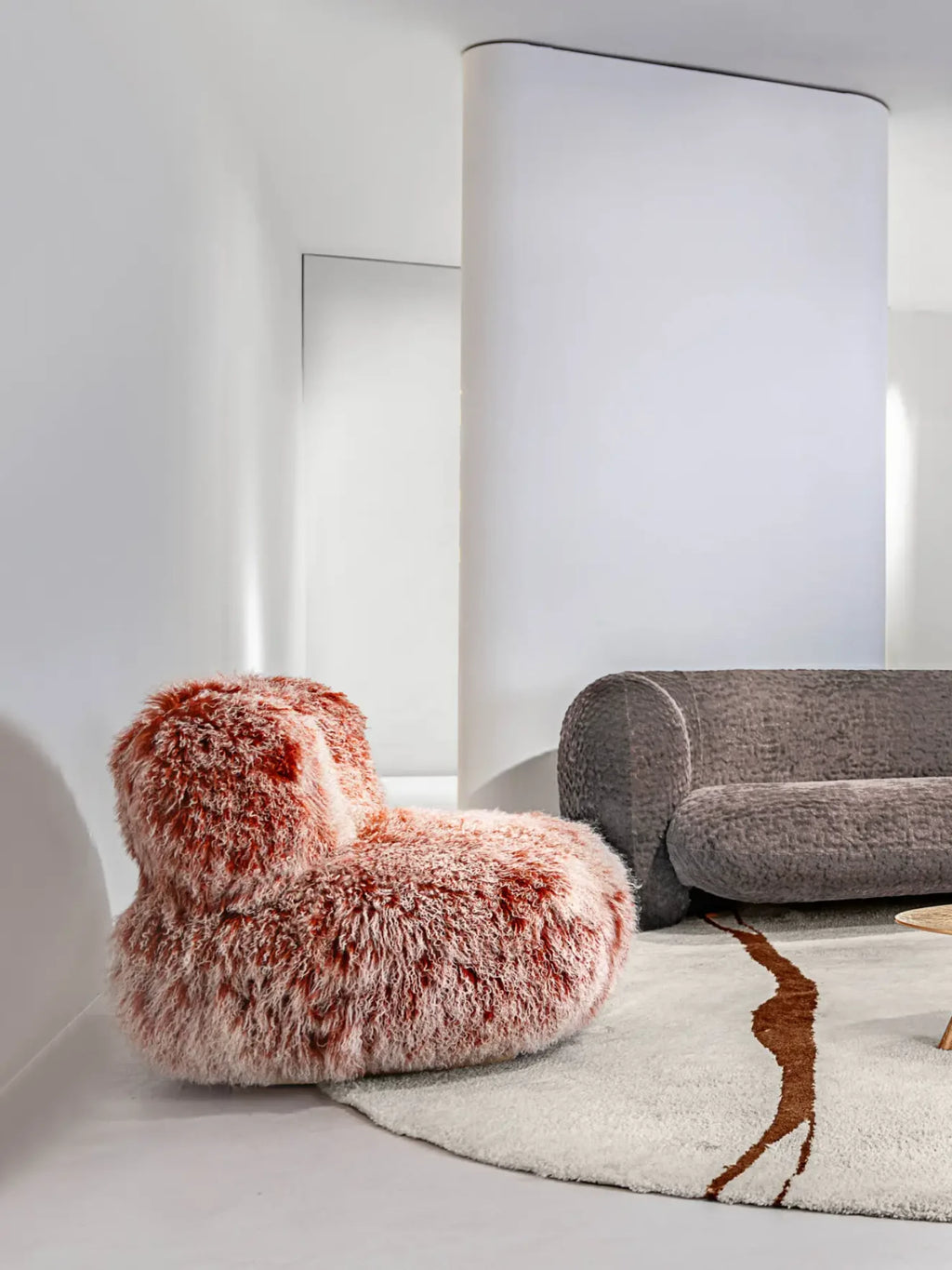 Hessentia Lullaby Armchair, a contemporary organic modern lounge chair featuring a plush, shaggy reddish-orange and cream faux fur upholstery with a soft, inviting texture.