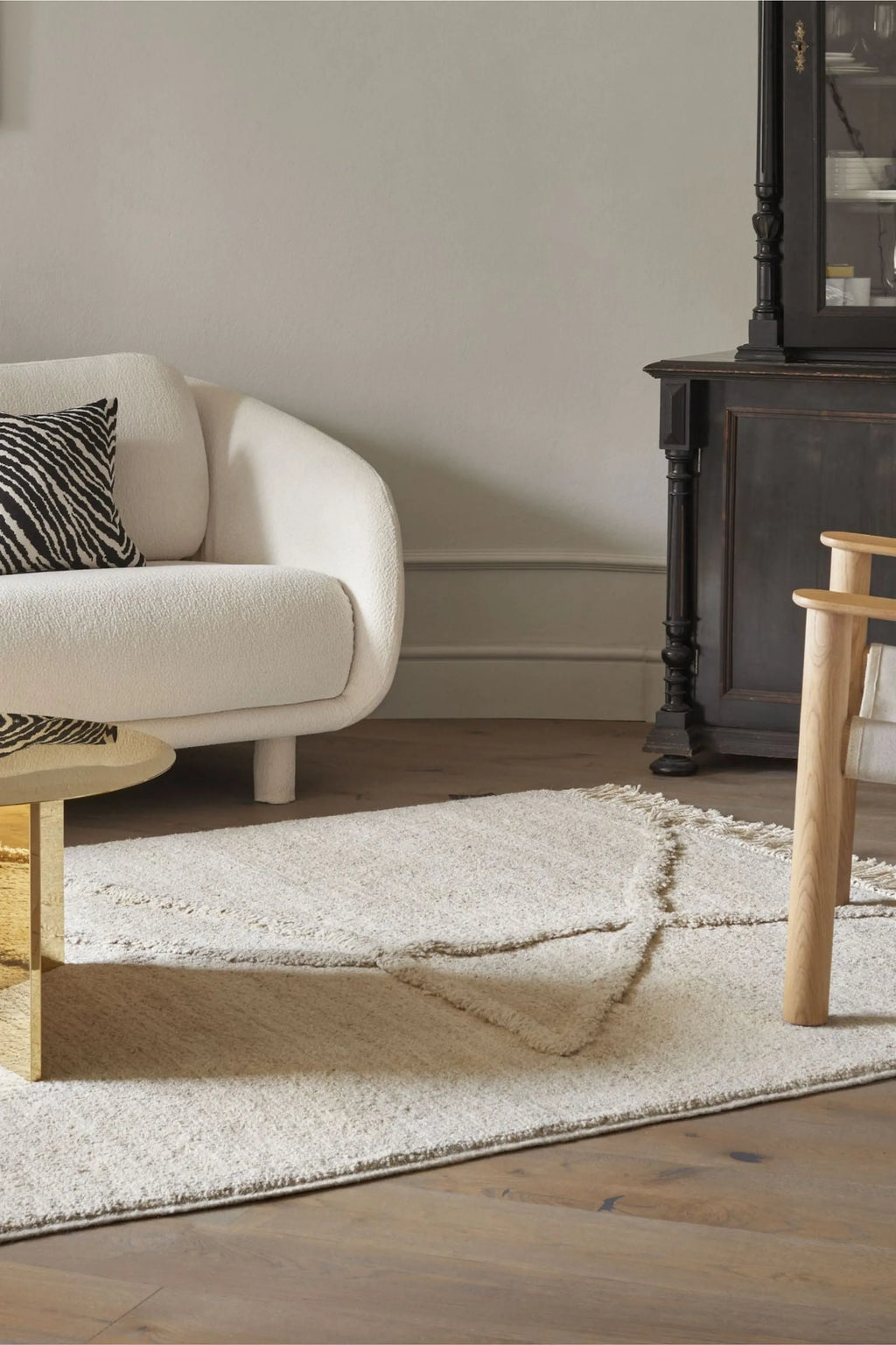 Sera Helsinki Vuoristo Rug, a plush hand-knotted wool area rug in natural cream and undyed off-white tones, featuring a unique raised organic pattern reminiscent of a mountain range.