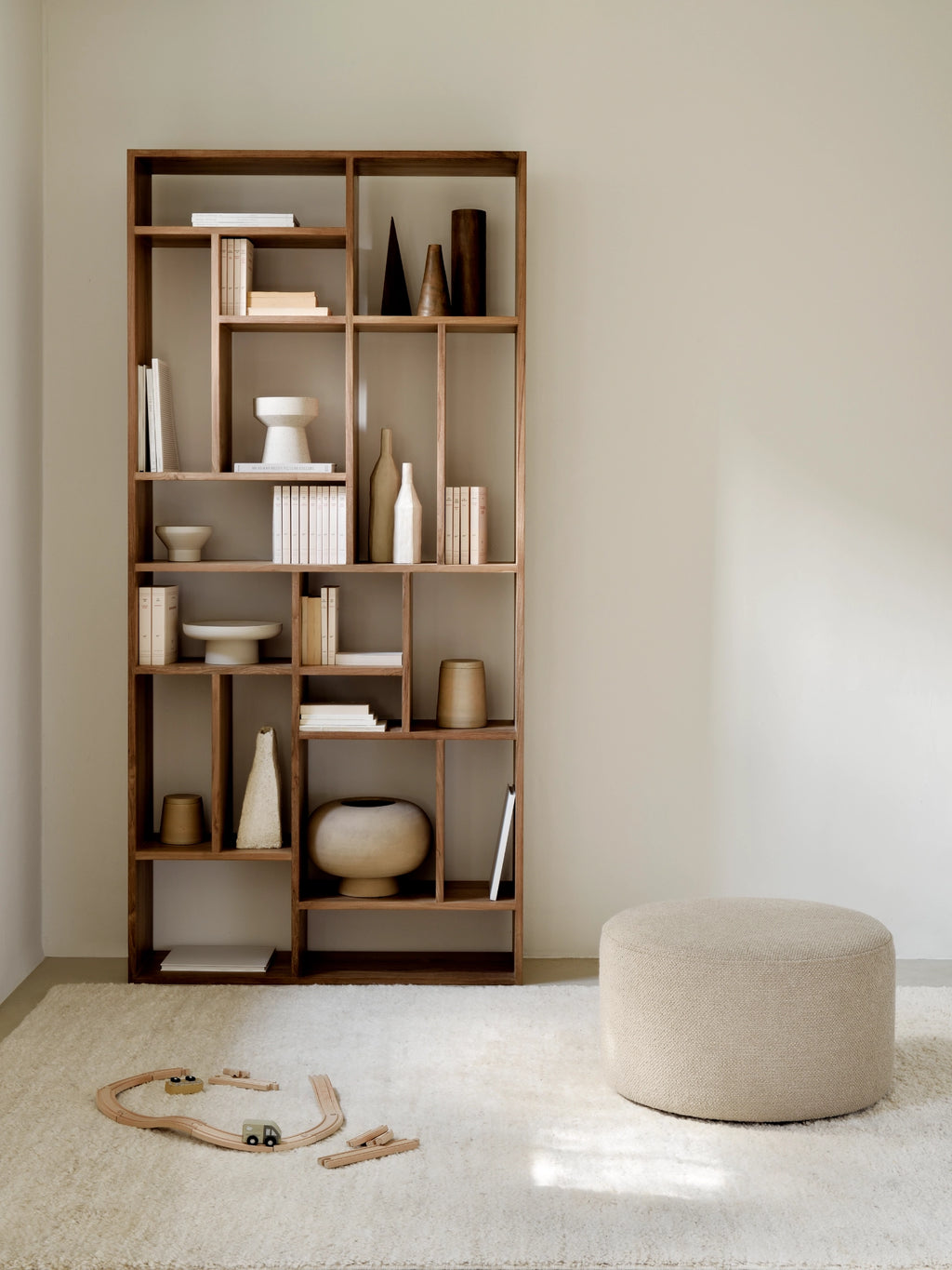 Ethnicraft Barrow Pouf, a round, cylindrical pouf upholstered in a textured cream bouclé fabric, featuring a natural, neutral beige hue and a soft, inviting weave. This contemporary and organic modern accent piece is perfect for minimalist living rooms, cozy reading nooks, or Scandinavian-inspired bedrooms.