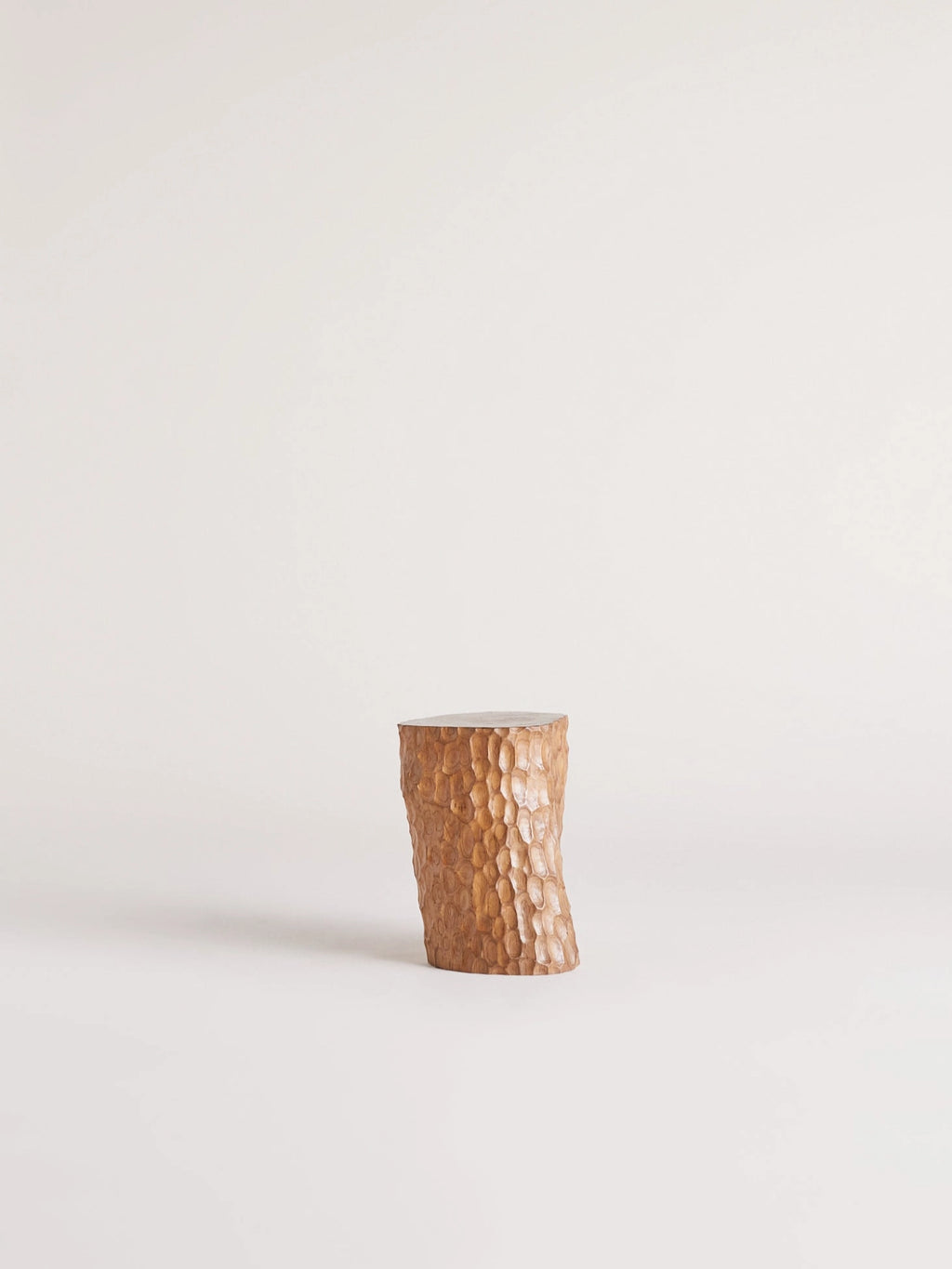 Heaps & Woods Clara Stool, a solid wood accent stool featuring a deeply hand-carved, organic texture across its warm natural wood surface and an irregular, sculptural silhouette. This rustic yet refined piece offers a unique wabi-sabi aesthetic with its natural finish. Perfect as an organic modern side table, bedside stool, or decorative plant stand for contemporary living rooms or bedrooms.