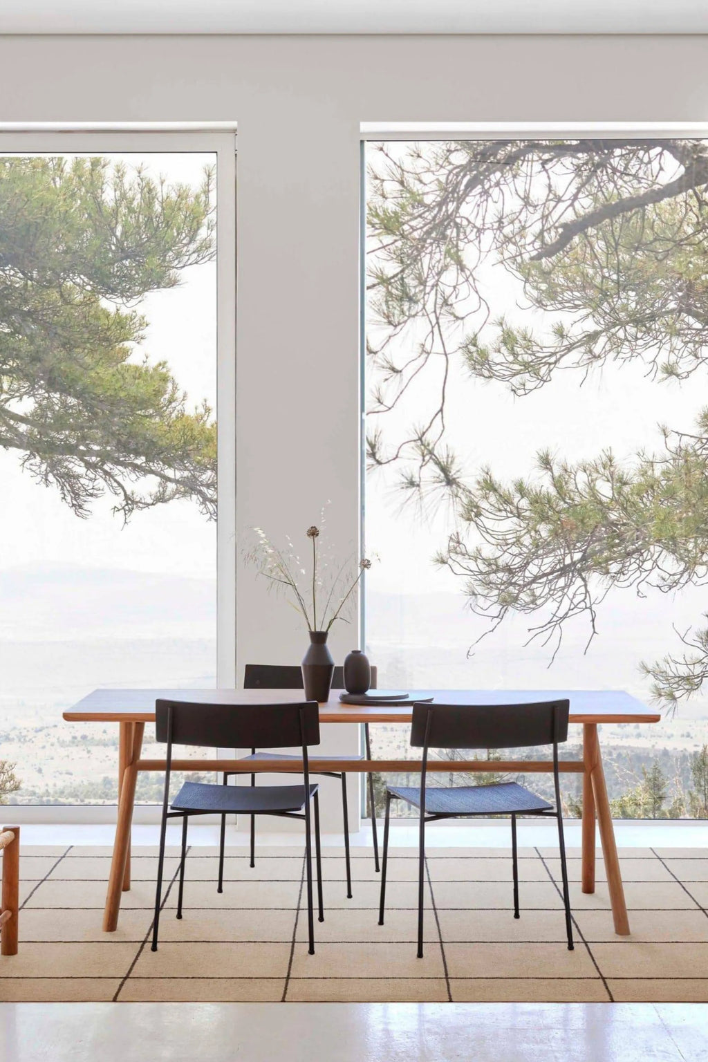 GAN Rugs Roots 001 Rug, a modern minimalist hand-woven wool area rug featuring a light natural beige background with a bold black geometric grid pattern, offering a subtly textured flat weave. This contemporary rectangular floor rug is perfect for defining dining room spaces, adding a sophisticated Scandinavian touch to living rooms, or enhancing minimalist interiors.