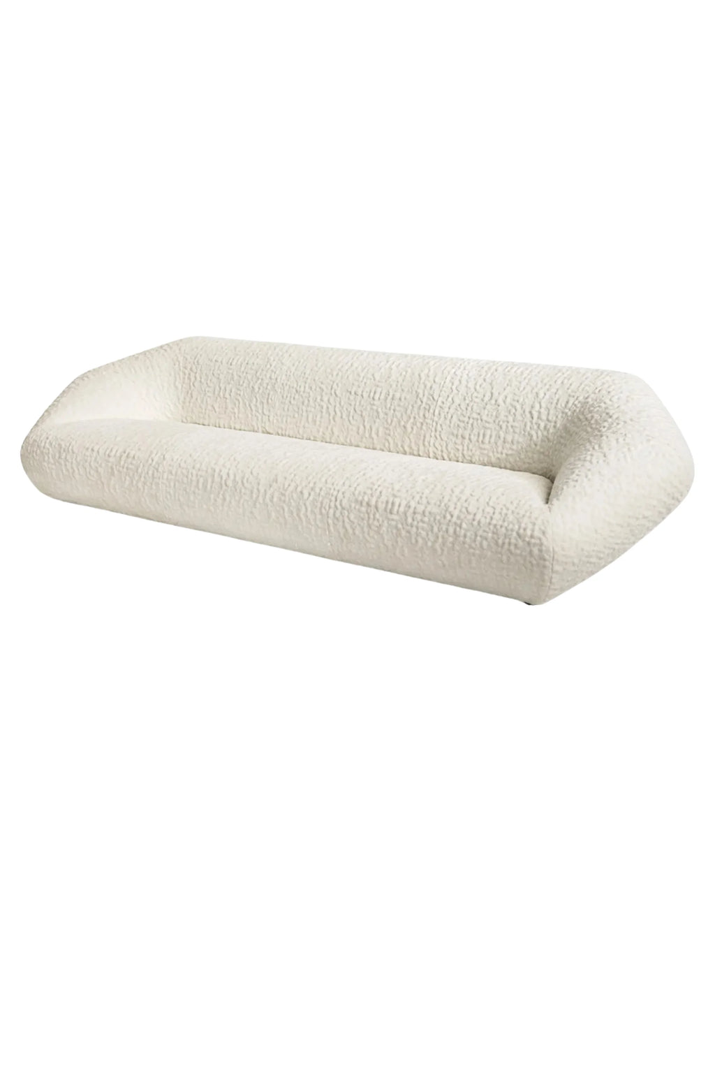 Hessentia Bloom Sofa, an organic modern sofa upholstered in luxurious cream bouclé fabric with a soft, textured finish and a low-profile, elongated, sculptural silhouette. Its armless design and gently rounded edges create contemporary, inviting lounge seating ideal for minimalist living rooms or sophisticated modern spaces.