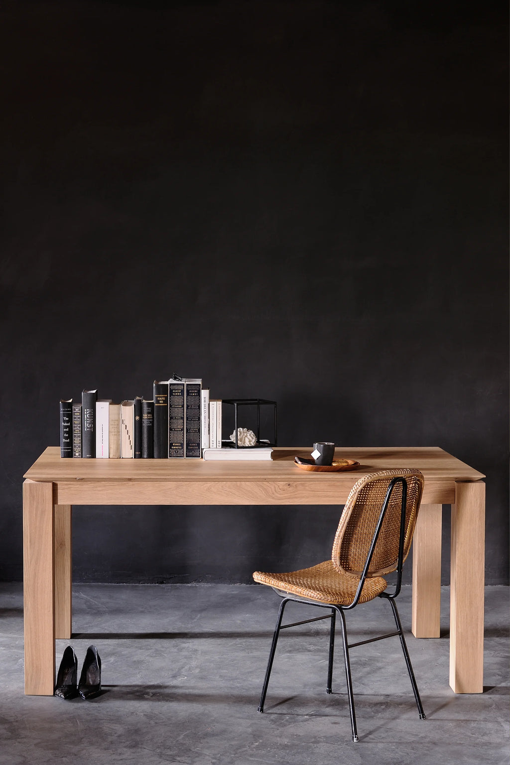 Ethnicraft Slice Extendable Dining Table, a modern minimalist dining table crafted from natural solid oak wood with a light, warm finish. It features a thick rectangular tabletop and sturdy, clean-lined block legs, showcasing the beautiful natural wood grain and high-quality craftsmanship. This versatile extendable oak table is perfect as a contemporary dining room centerpiece or a spacious home office desk for Scandinavian and modern interiors.