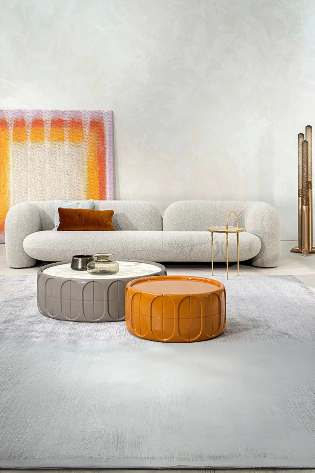 Hessentia Gio Sofa, a contemporary organic modern sofa upholstered in a plush light grey bouclé fabric, featuring a low-profile design with softly rounded, plump armrests and back. Its gentle curves create a welcoming, minimalist aesthetic. Ideal for a modern living room, minimalist apartment, or a cozy, design-conscious lounge space.