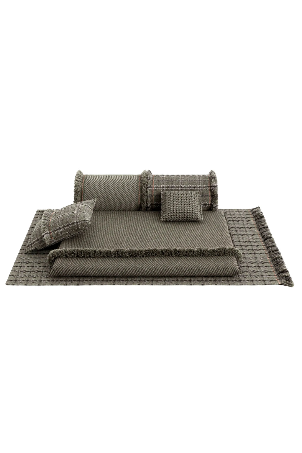 GAN Rugs Garden Layers Composition 03, an organic modern outdoor lounge set in a rich olive green, featuring a large rectangular mat with a textured diagonal weave and fringed edges with subtle reddish accents,.