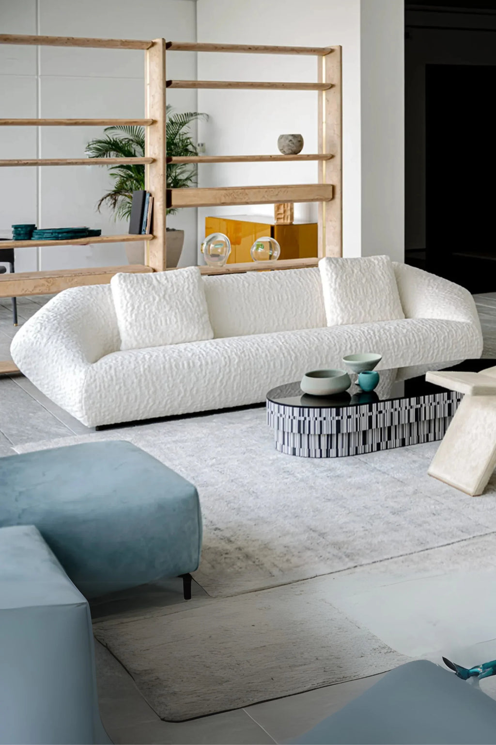 Hessentia Bloom Sofa, an off-white organic modern sofa upholstered in plush, highly textured bouclé fabric with a distinctive wavy pattern and a low, rounded profile. This contemporary sculptural sofa features a deep, comfortable seat and three matching textured back cushions. Ideal as a statement piece for minimalist living rooms or luxurious modern interiors.